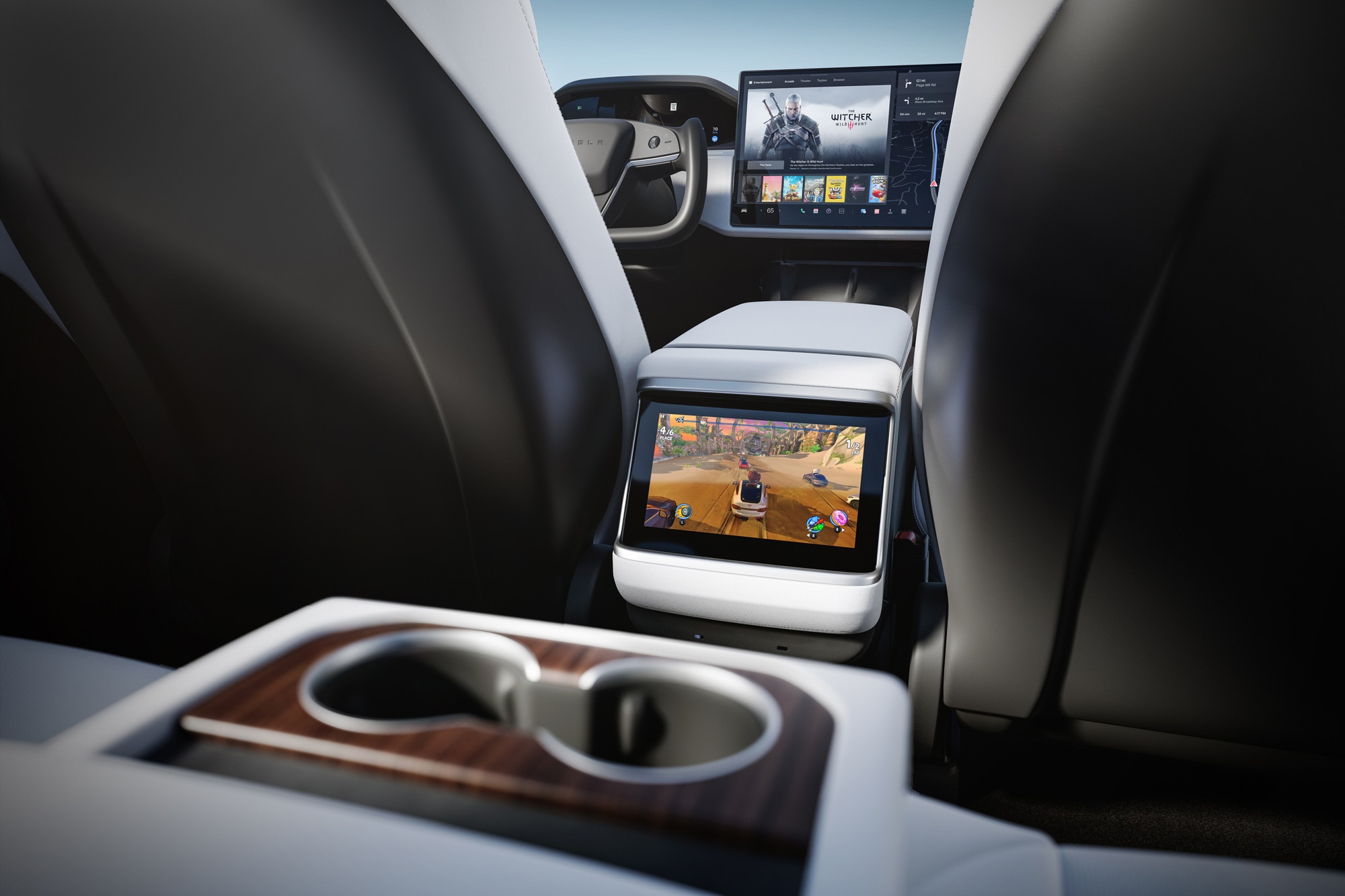 2023 Tesla Model S interior showing cupholder and multiple infotainment screens