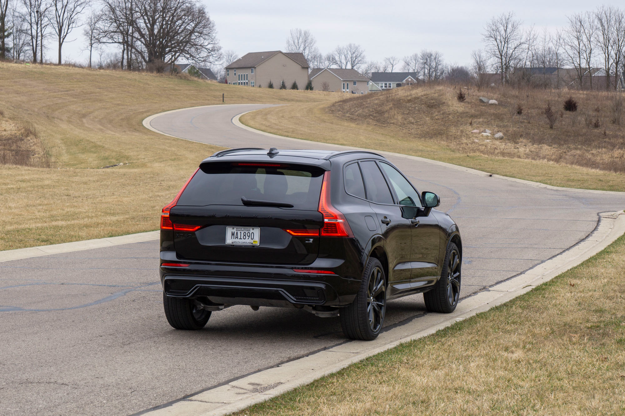 Rear of a 2024 Volvo XC60 Recharge in Ultimate Black Edition parked on a street