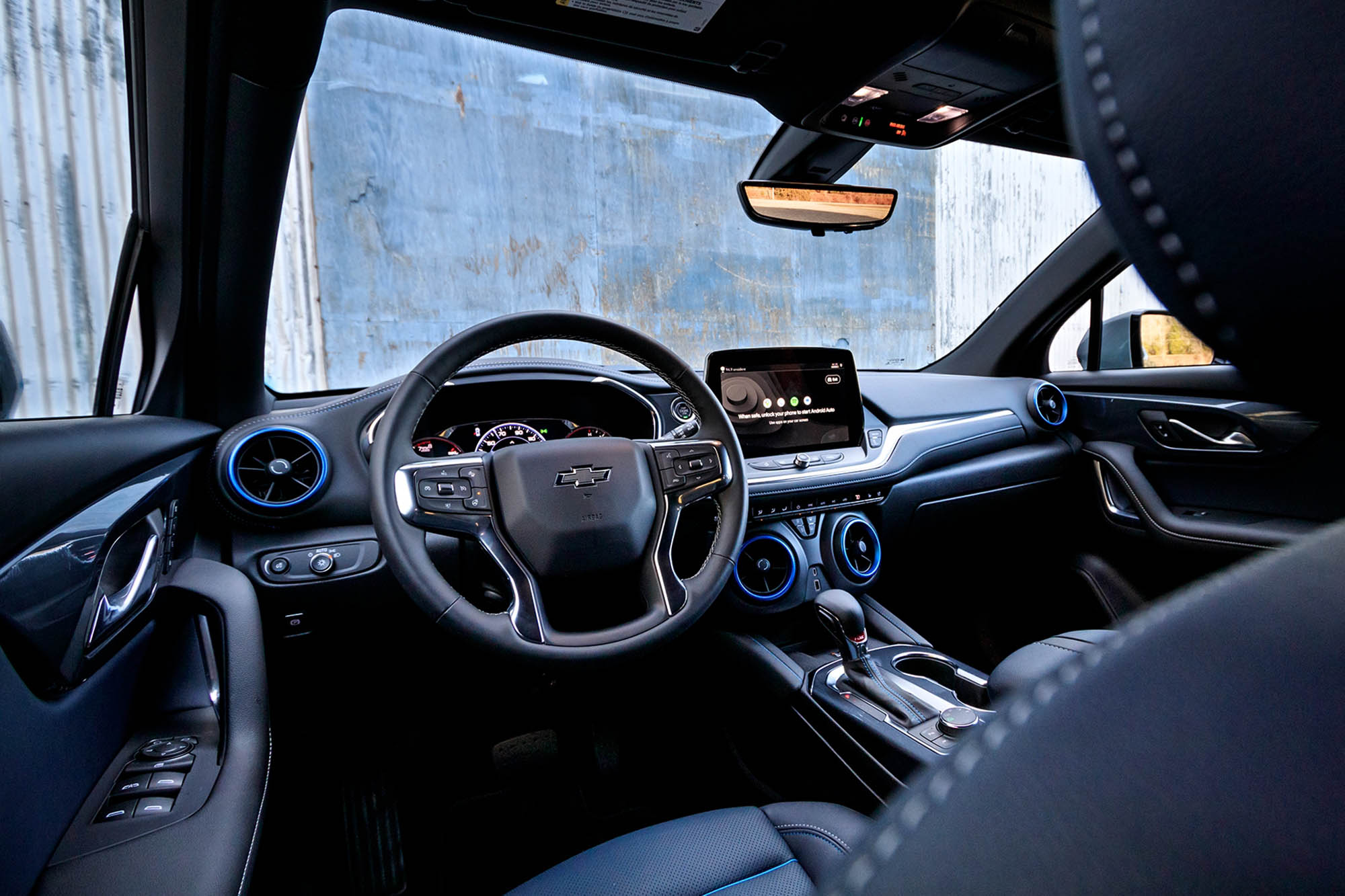 View of the dashboard of a 2024 Chevrolet Blazer RS with a barn visible through the windshield.