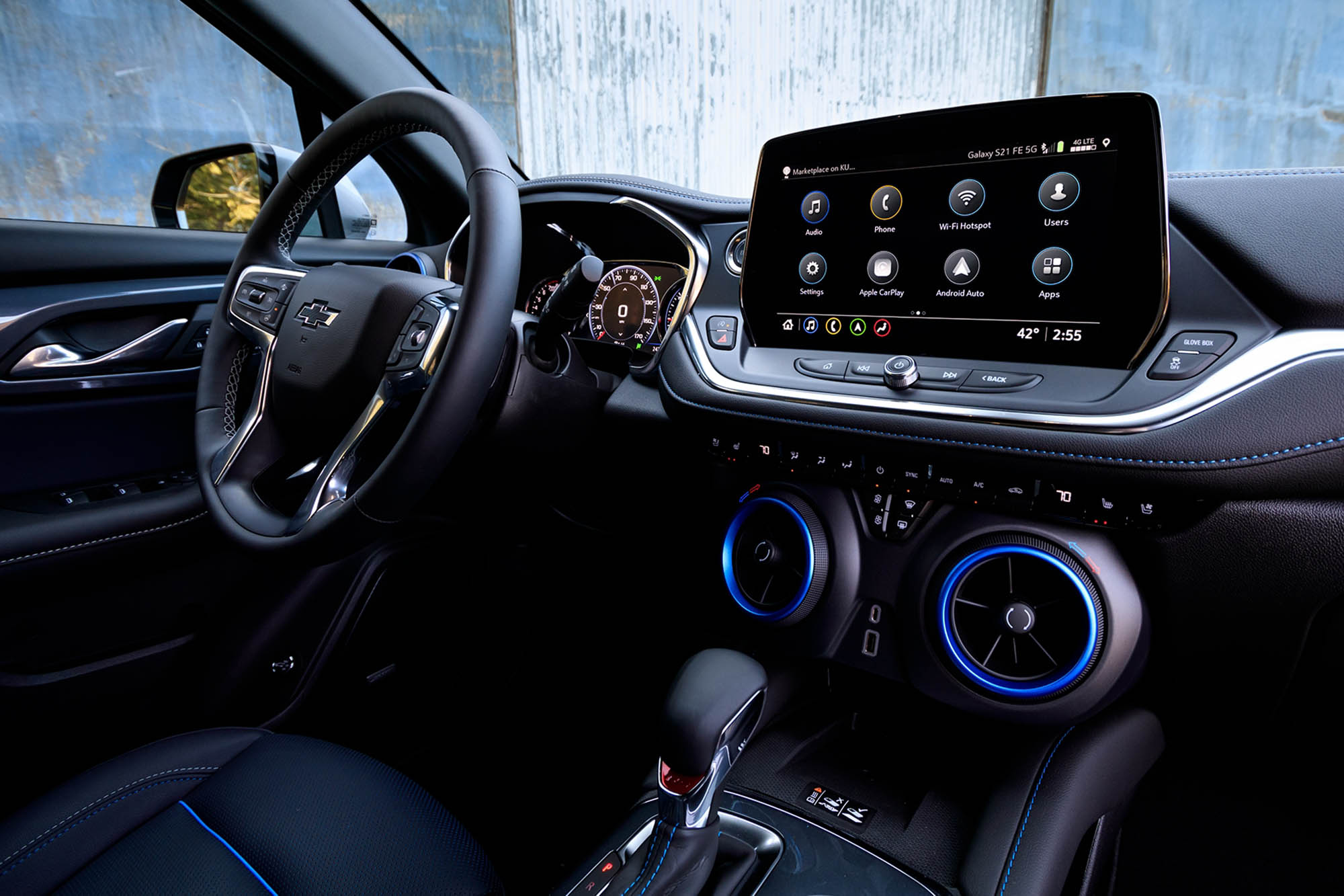 View of the infotainment system, climate control system, shifter, and steering wheel in a 2024 Chevrolet Blazer RS.