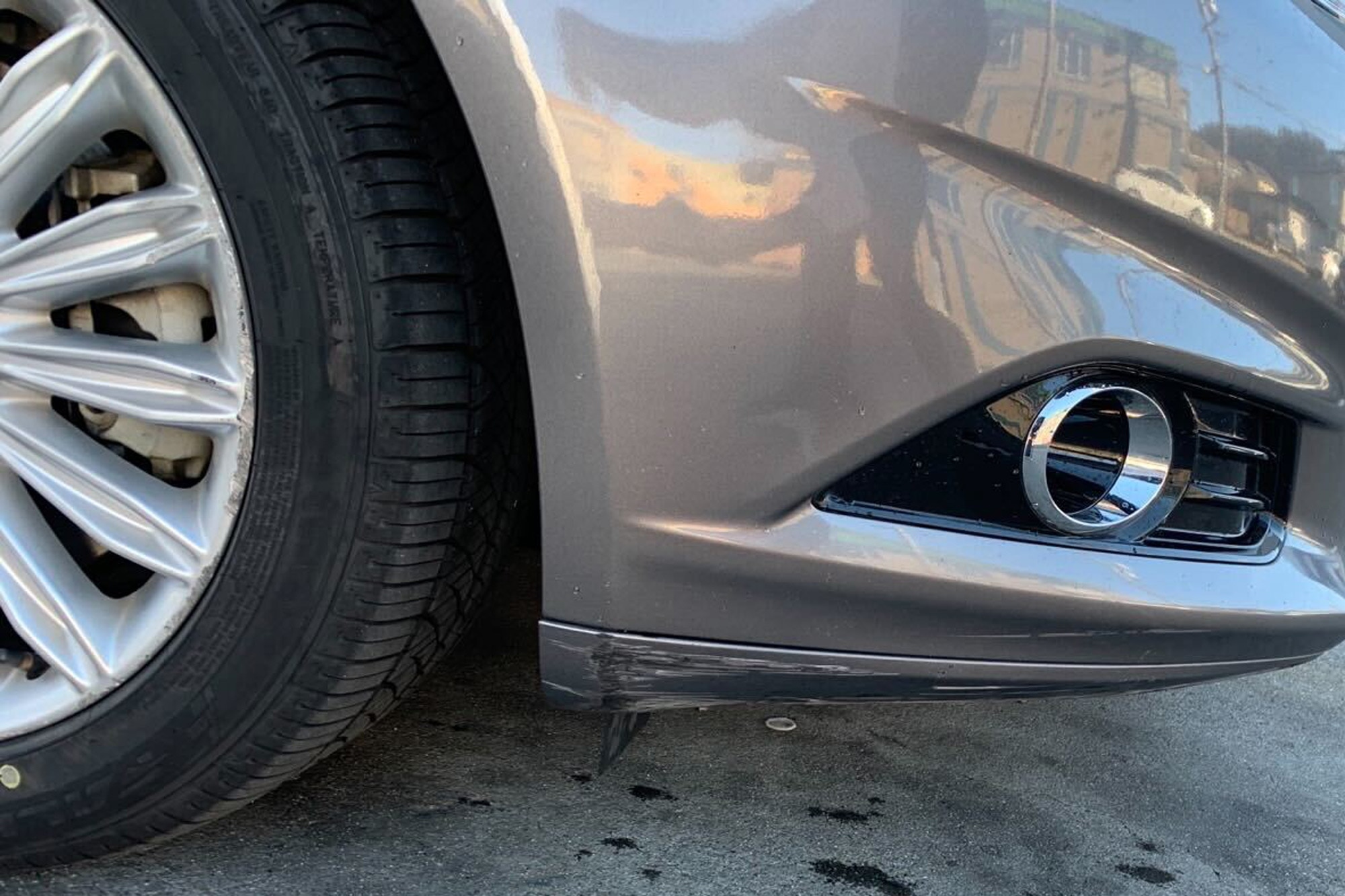 Front passenger side bumper of gray 2013 Ford Fusion Energi with curb rash