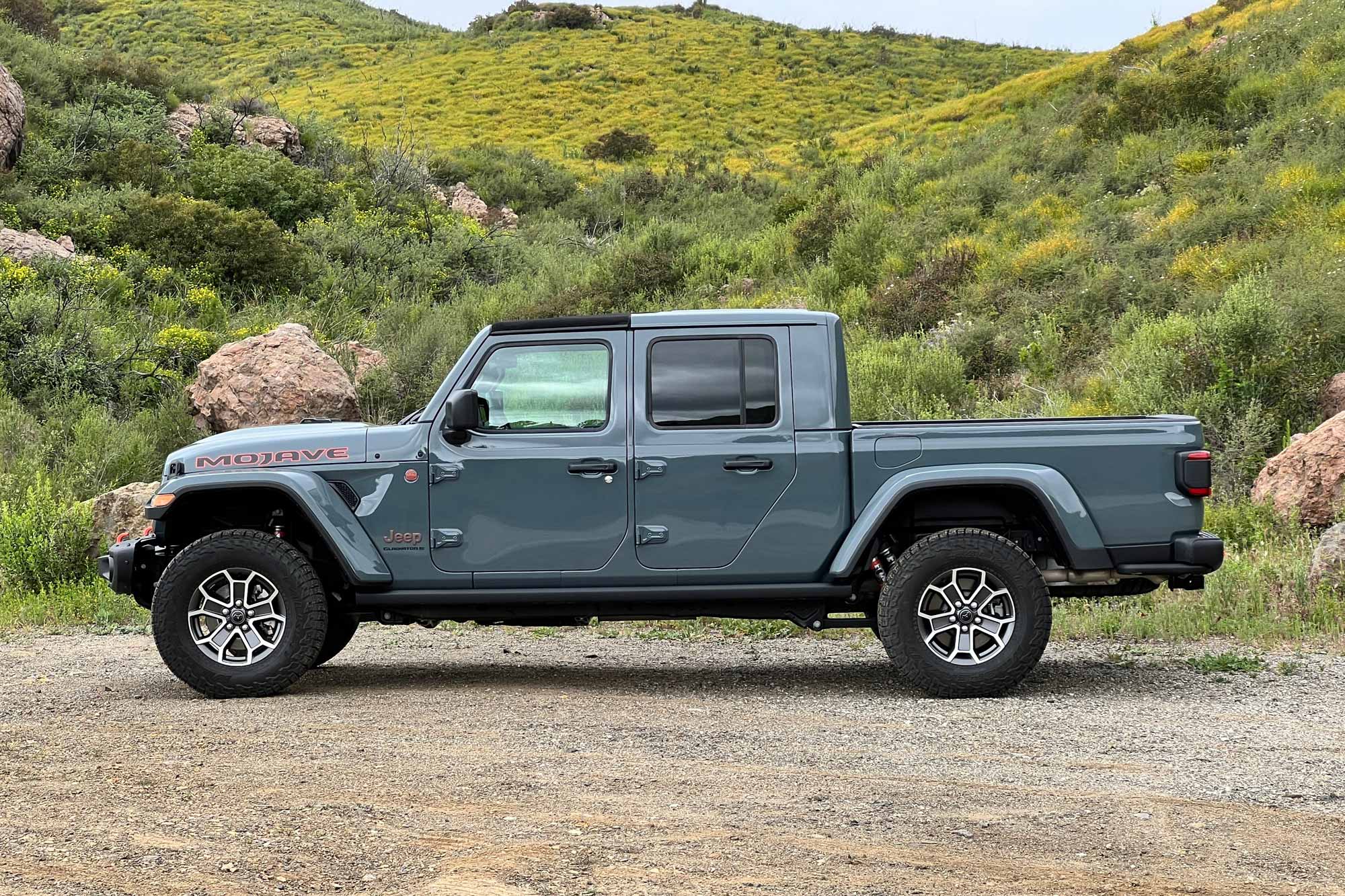 Side of a 2024 Jeep Gladiator Mojave X with Anvil paint parked in the Santa Monica Mountains