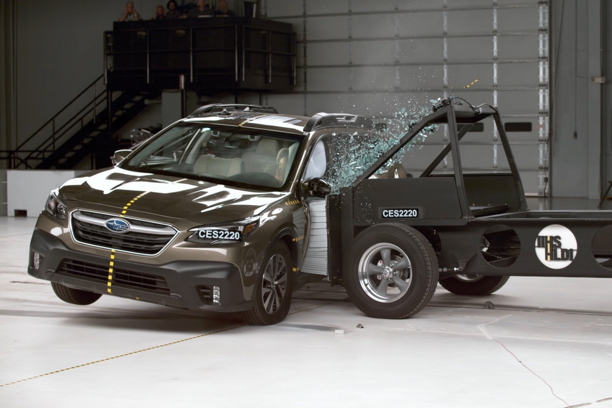 A 4,200-pound barrier is driven into the side of a Subaru Outback to test rear-seat safety