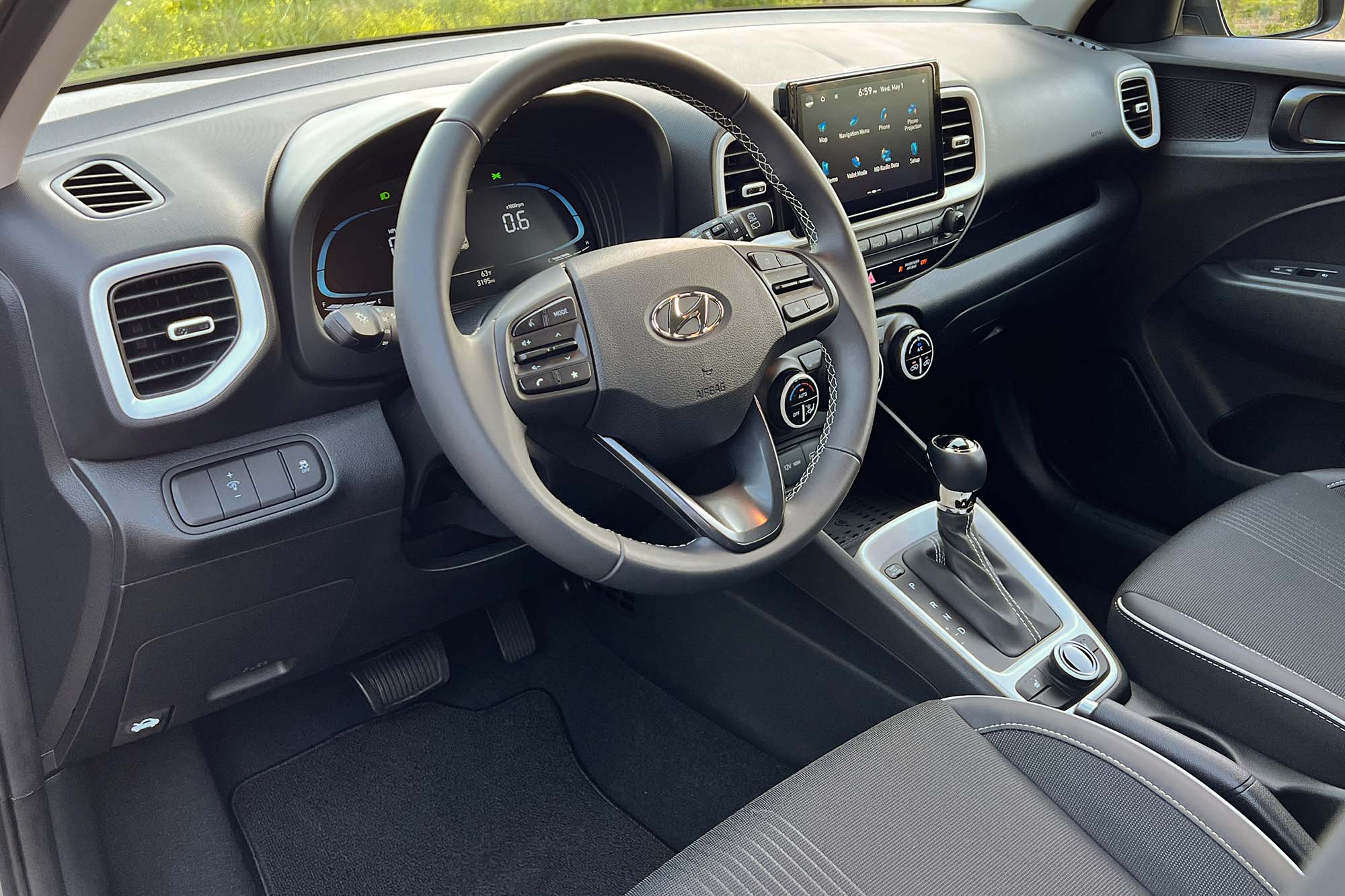 View of a 2024 Hyundai Venue Limited interior showing the dashboard and front seats.
