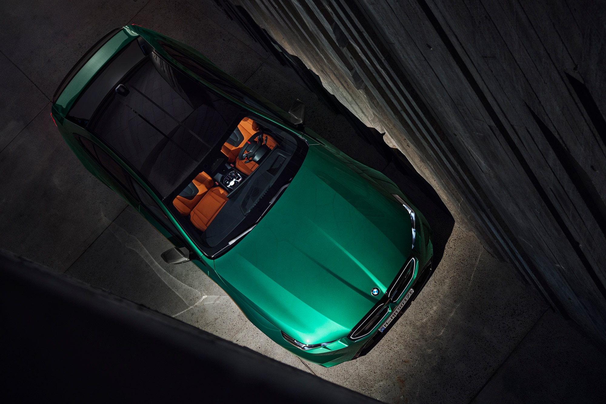 A green 2025 BMW M5 as seen from above