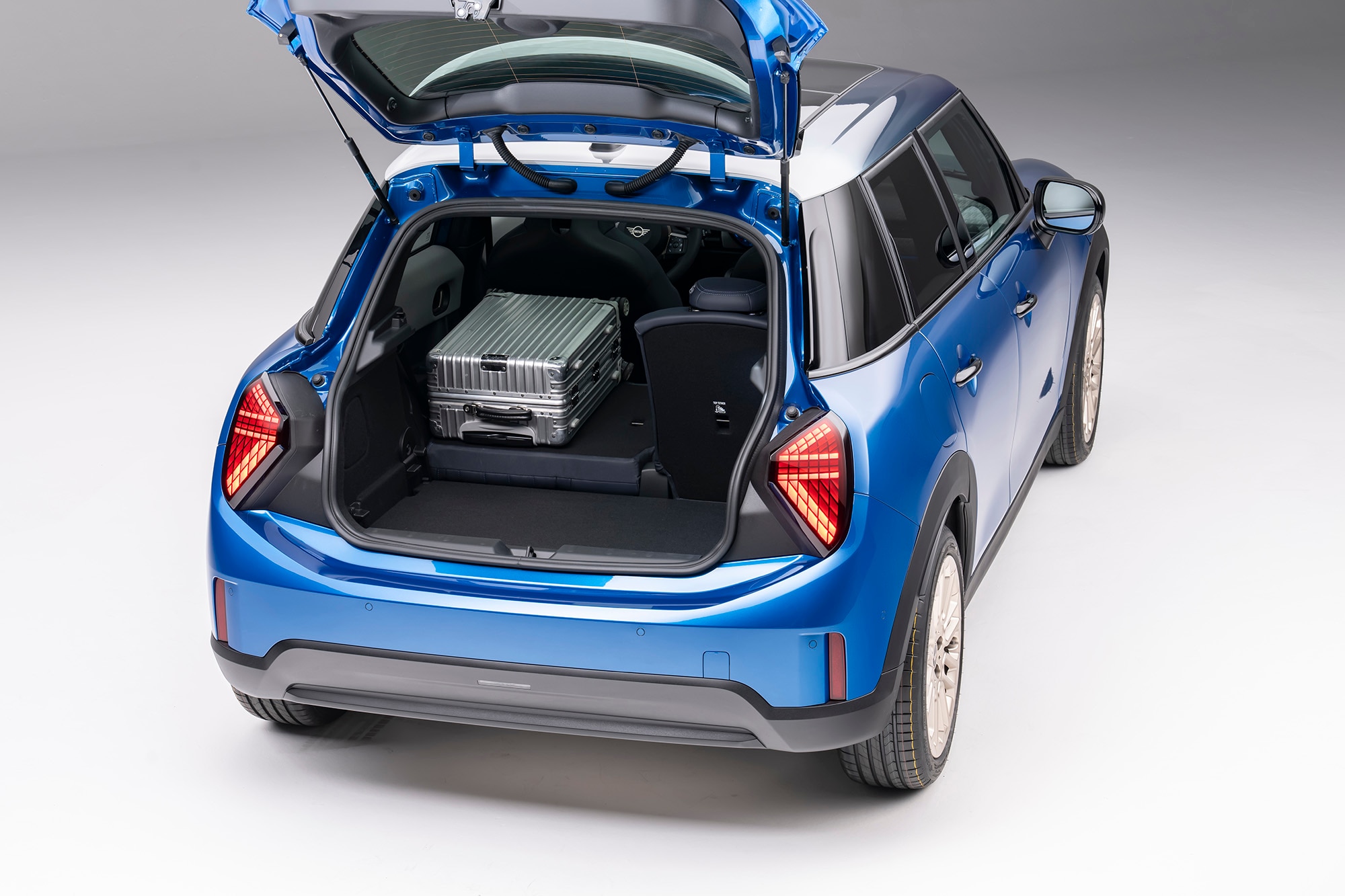 2025 Mini Cooper S 4-Door in blue, rear hatch open to show cargo space