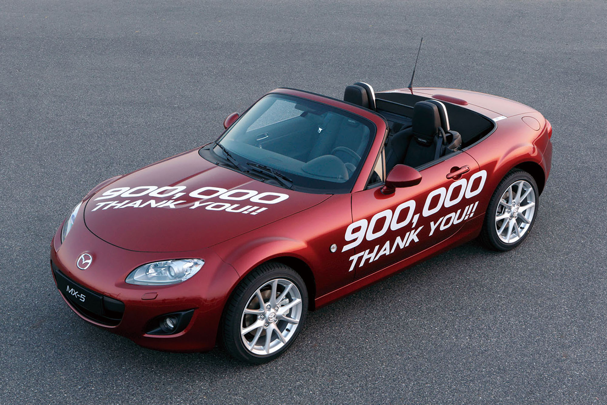 A Red Mazda Miata celebrating 900,000 units produced
