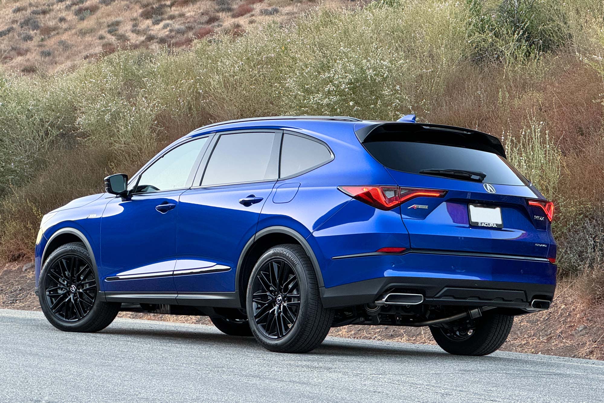 Rear of an Apex Blue 2025 Acura MDX A-Spec Advance