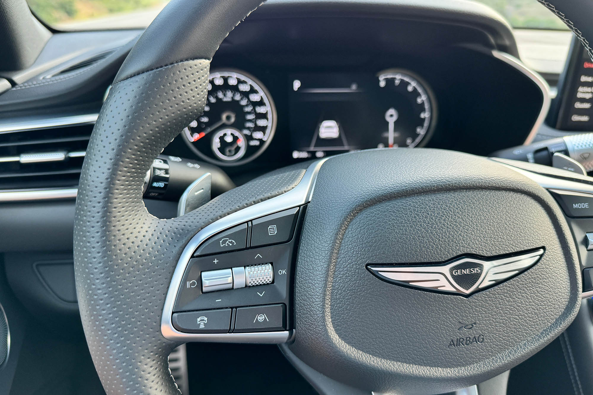 View of a 2024 Genesis G70 2.5T Sport Prestige interior showing the safety feature controls on the steering wheel