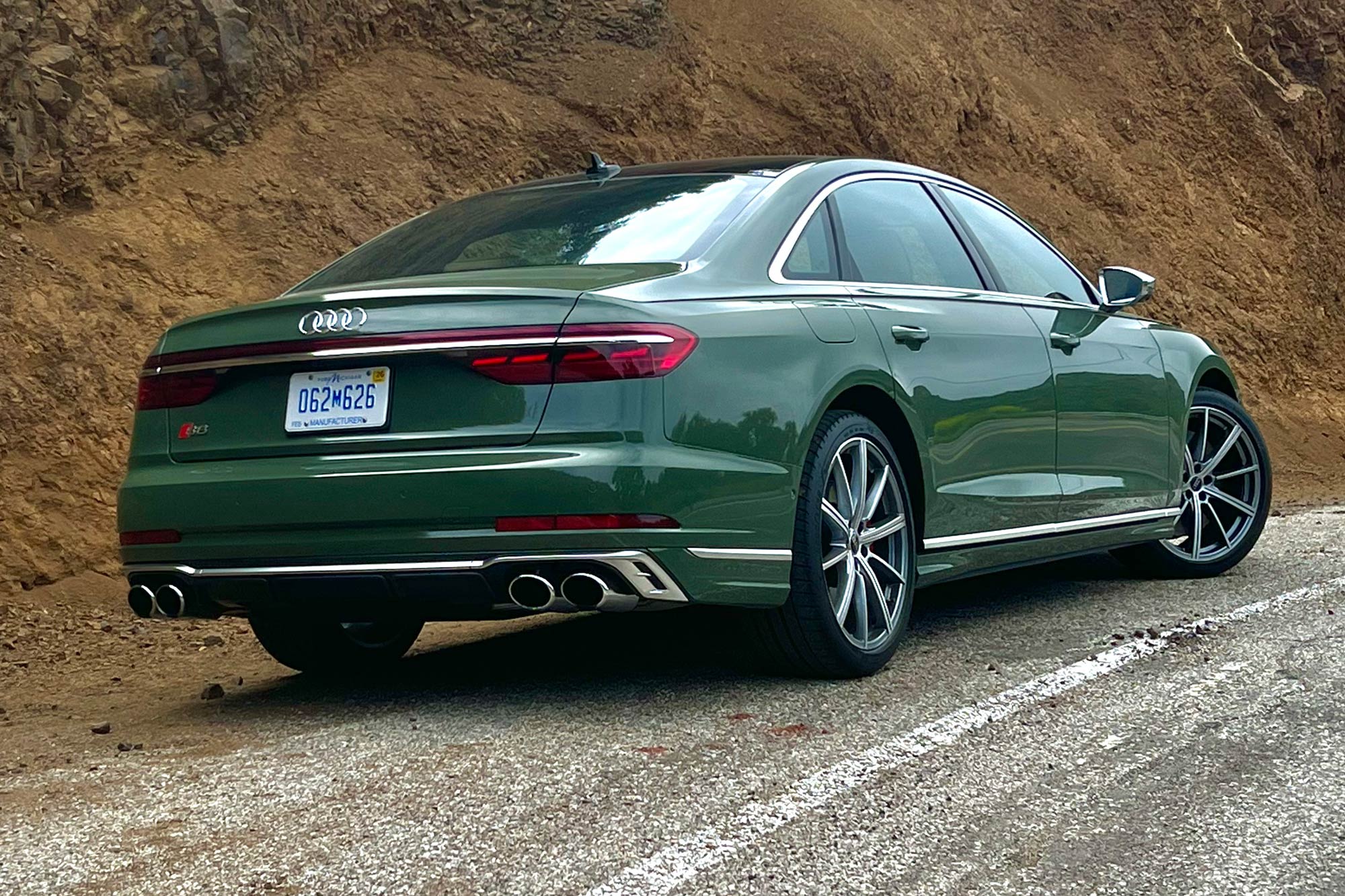 District Green 2024 Audi S8 parked on the side of a road.