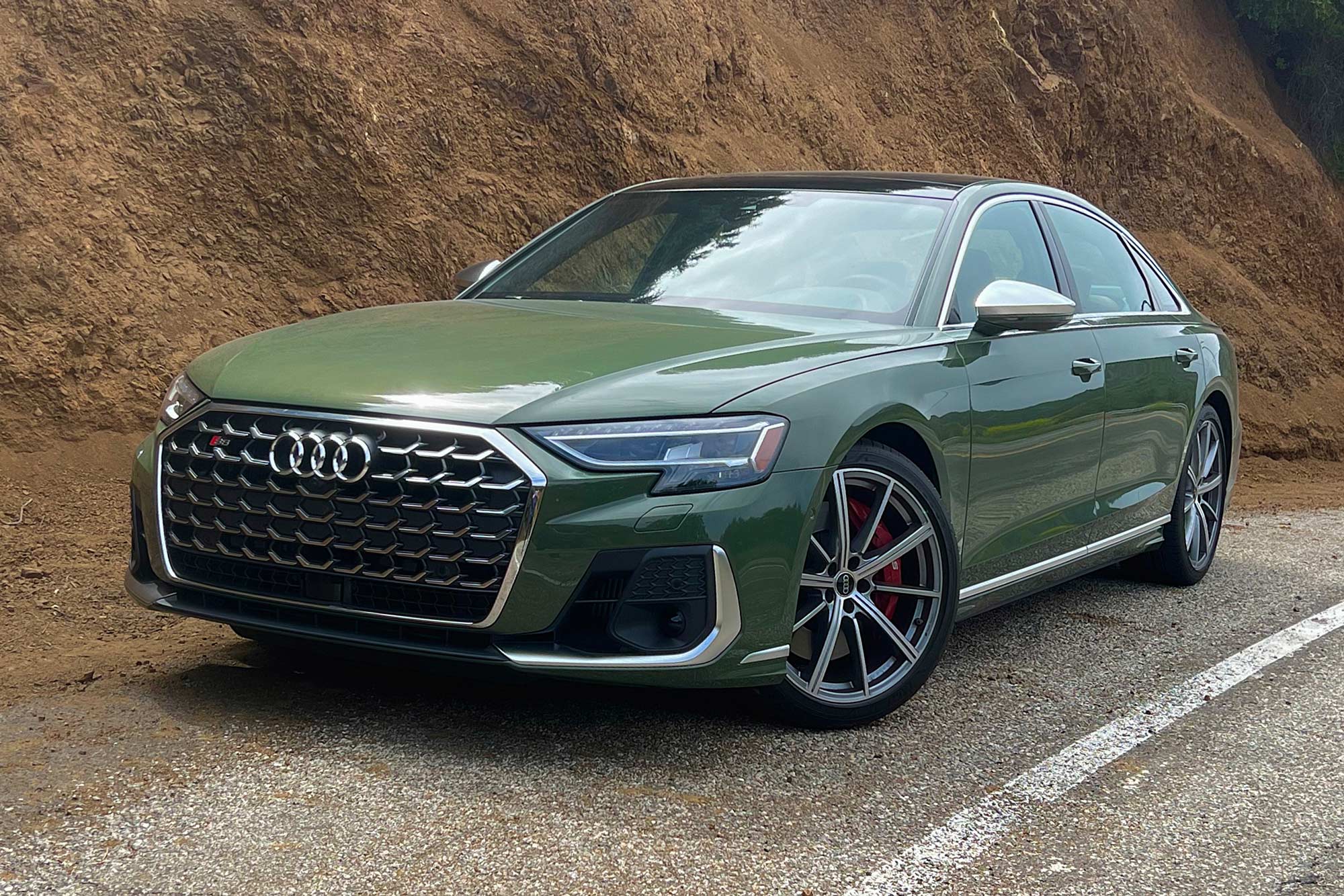 District Green 2024 Audi S8 parked on the side of a road.