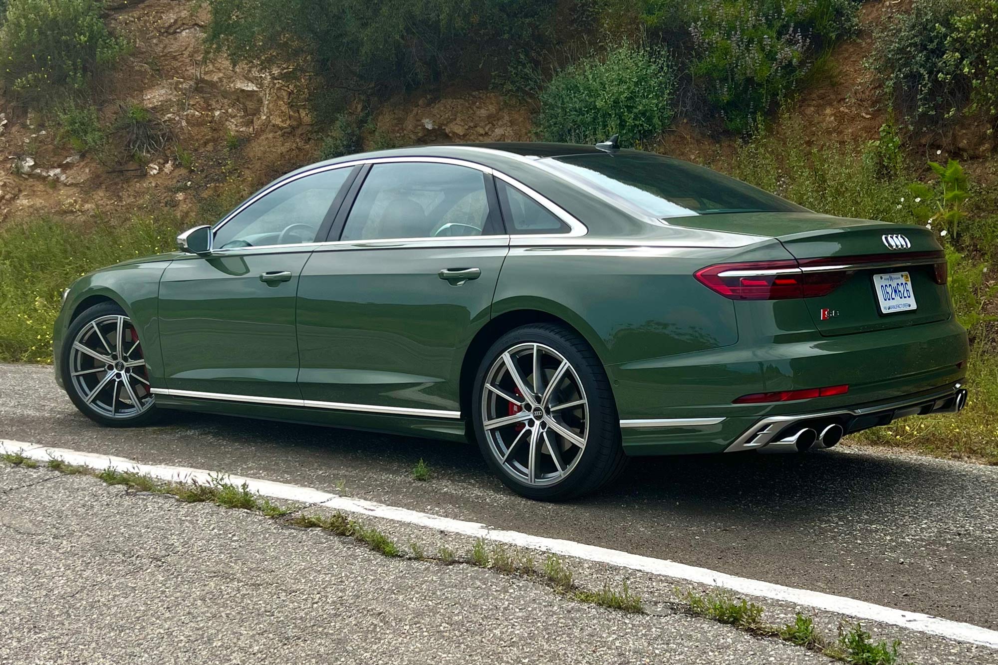 District Green 2024 Audi S8 parked on the side of a road.