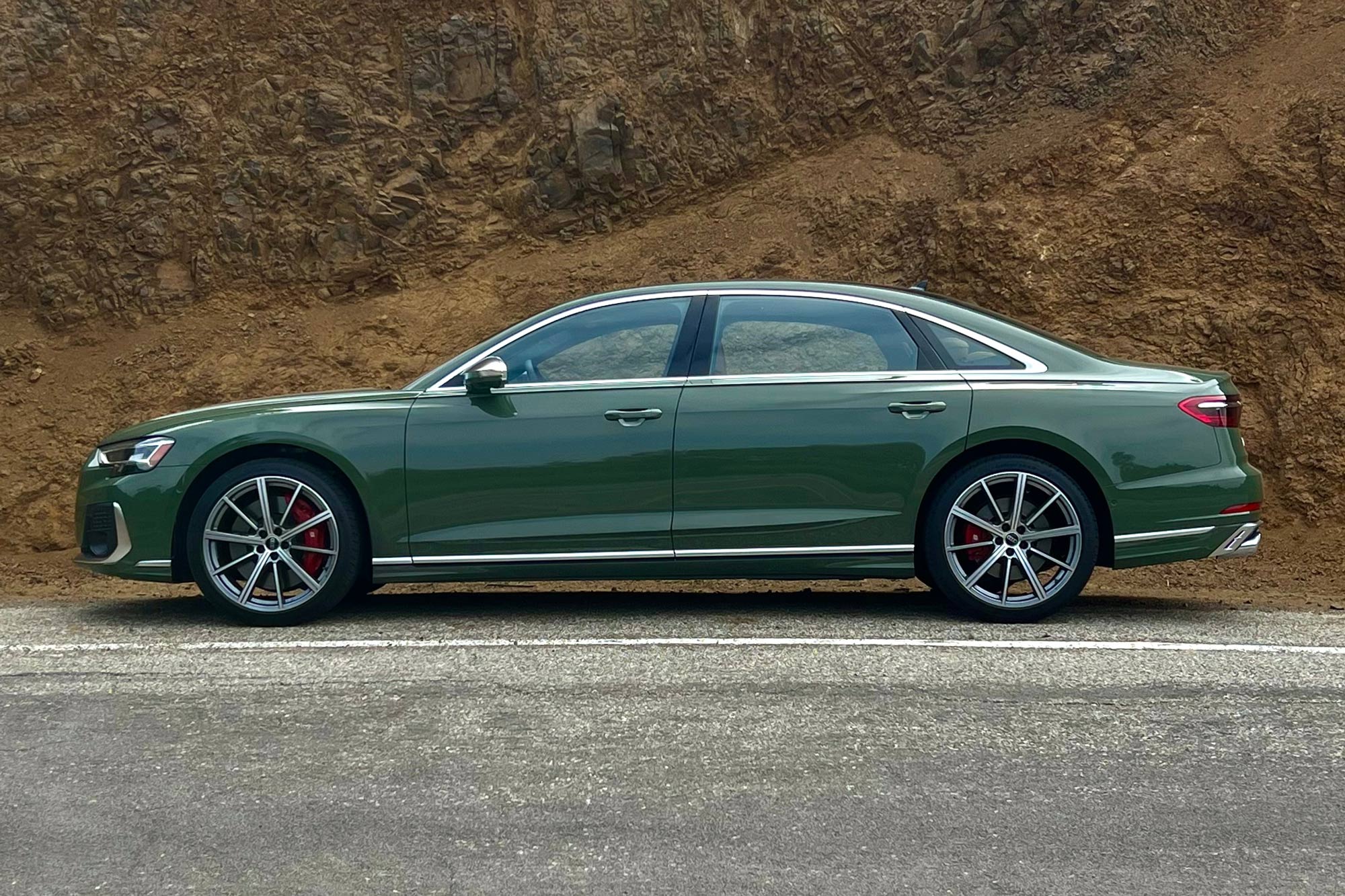 District Green 2024 Audi S8 parked on the side of a road.