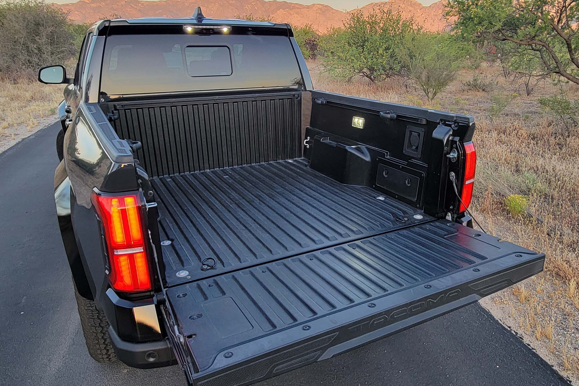 View of a 2024 Toyota Tacoma TRD Pro cargo bed with the tailgate down.