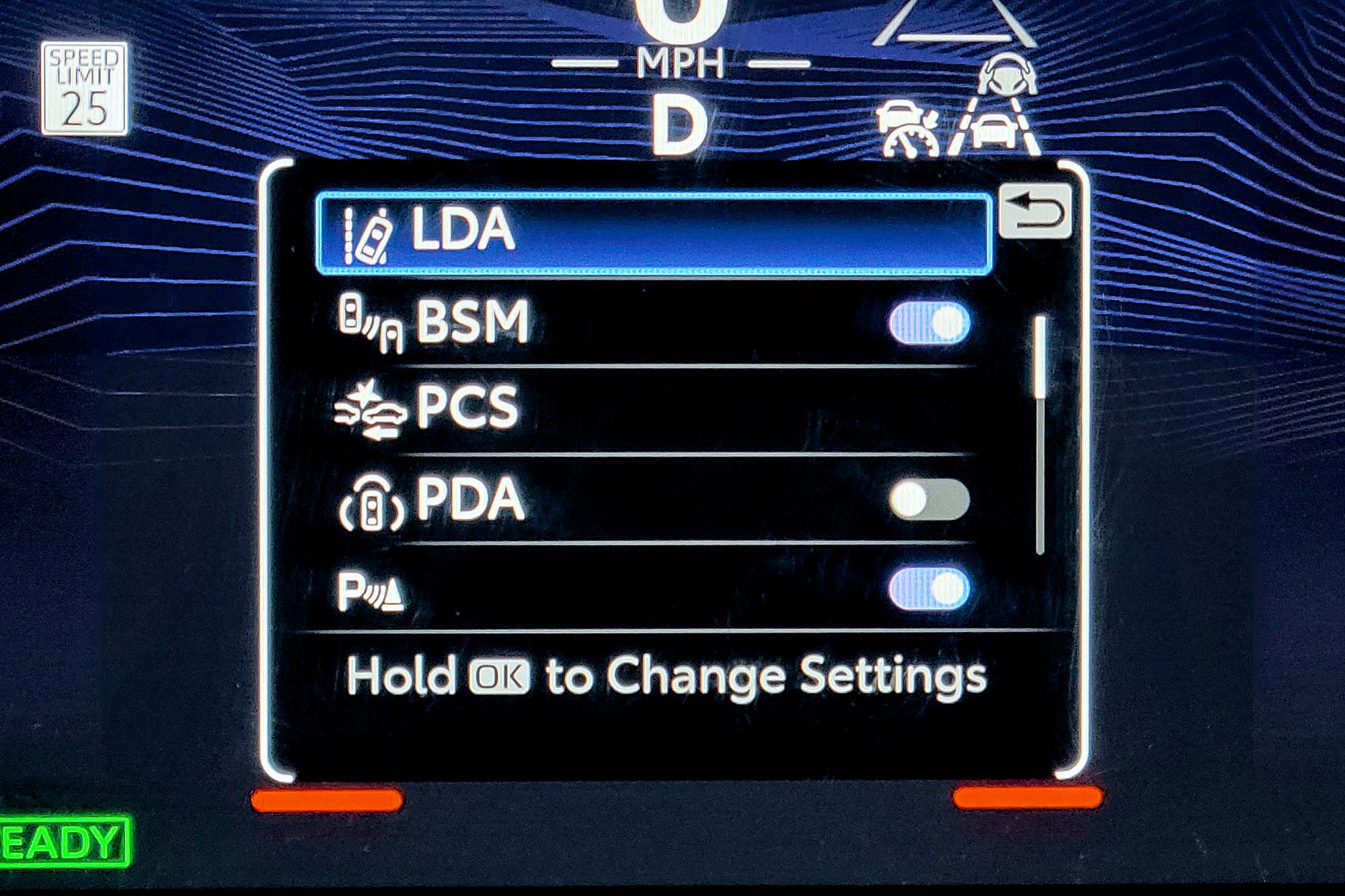 View of a 2024 Toyota Tacoma TRD Pro interior showing the safety feature menu within the digital instrumentation.