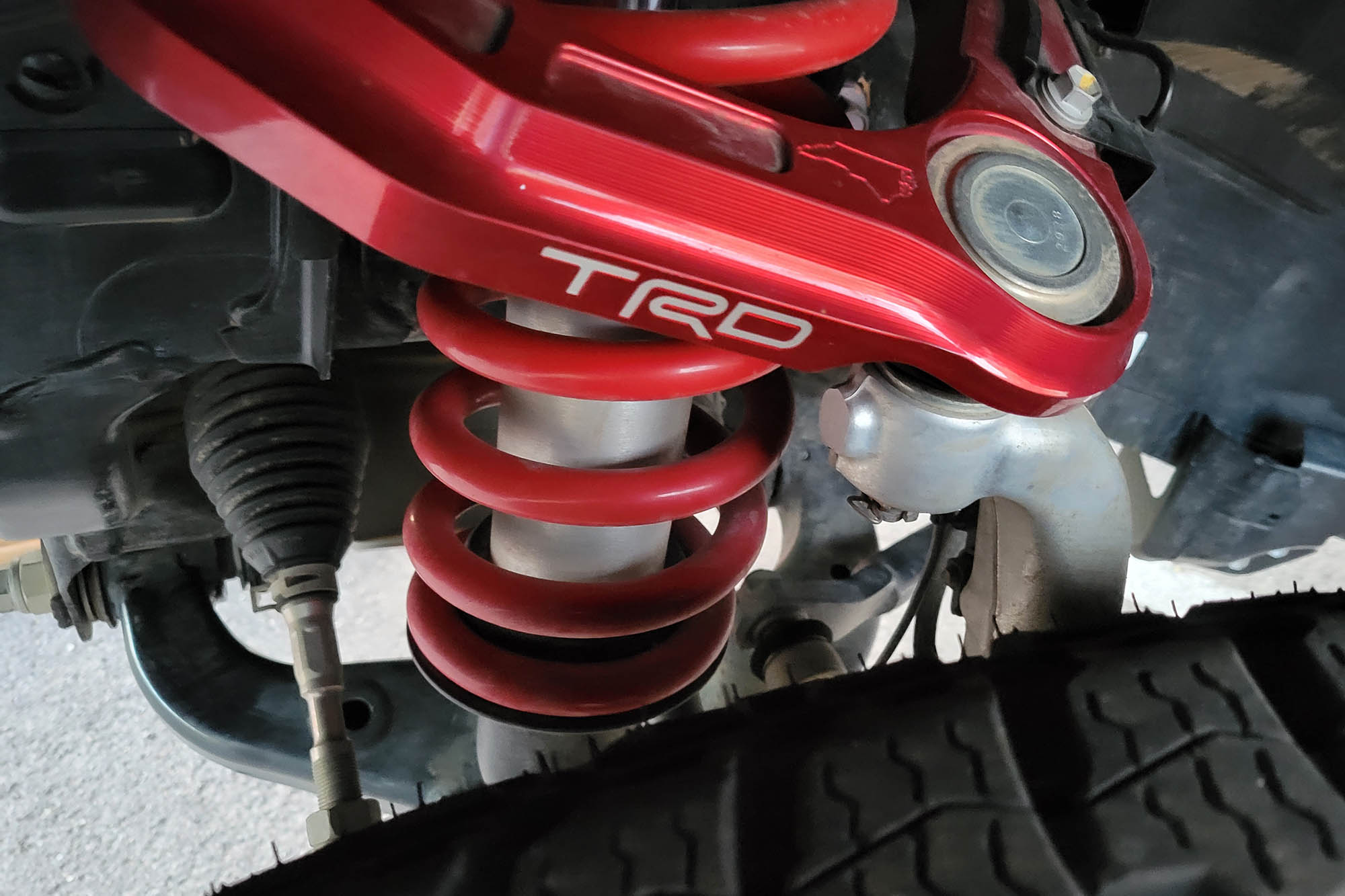 Close-up view of the Fox QS3 2.5-inch internal bypass shock absorber on a 2024 Toyota Tacoma TRD Pro.