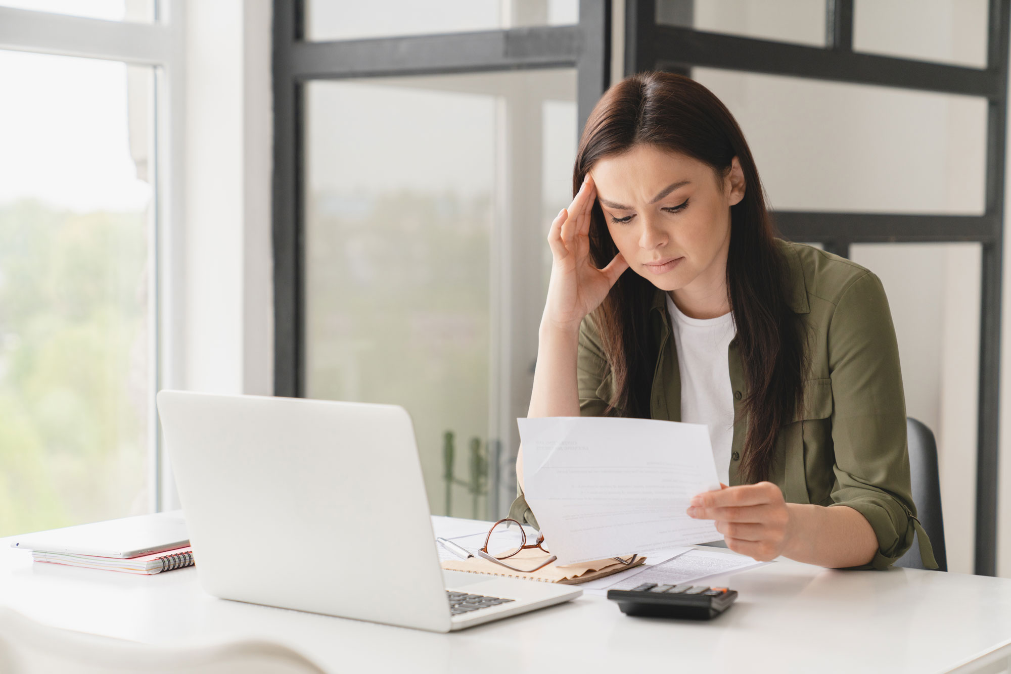 Person reviewing documents at computer