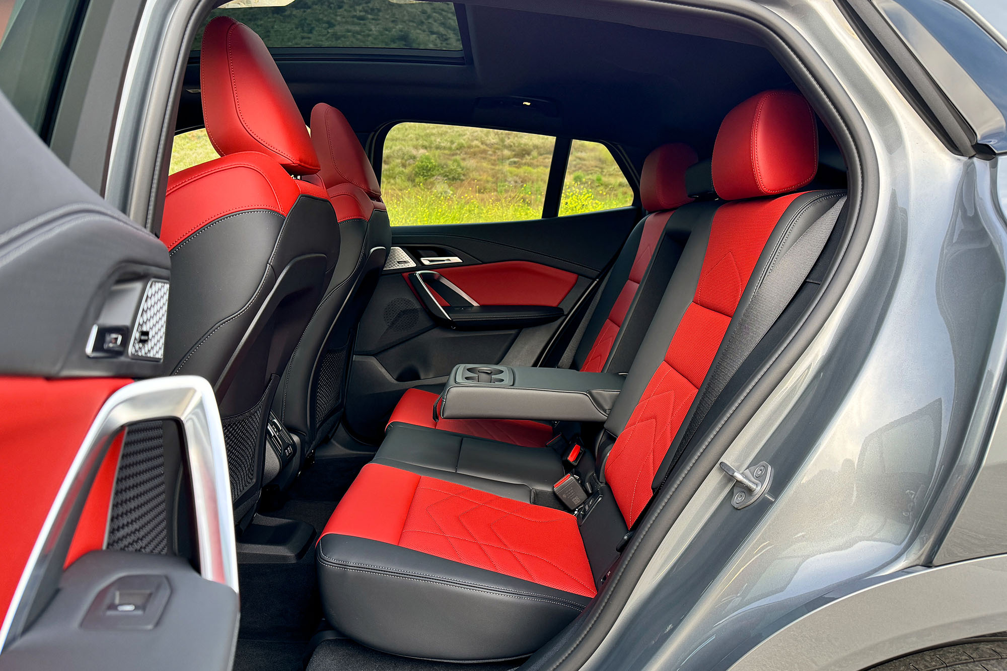 Rear interior of a 2024 BMW X2 with red seat insets.