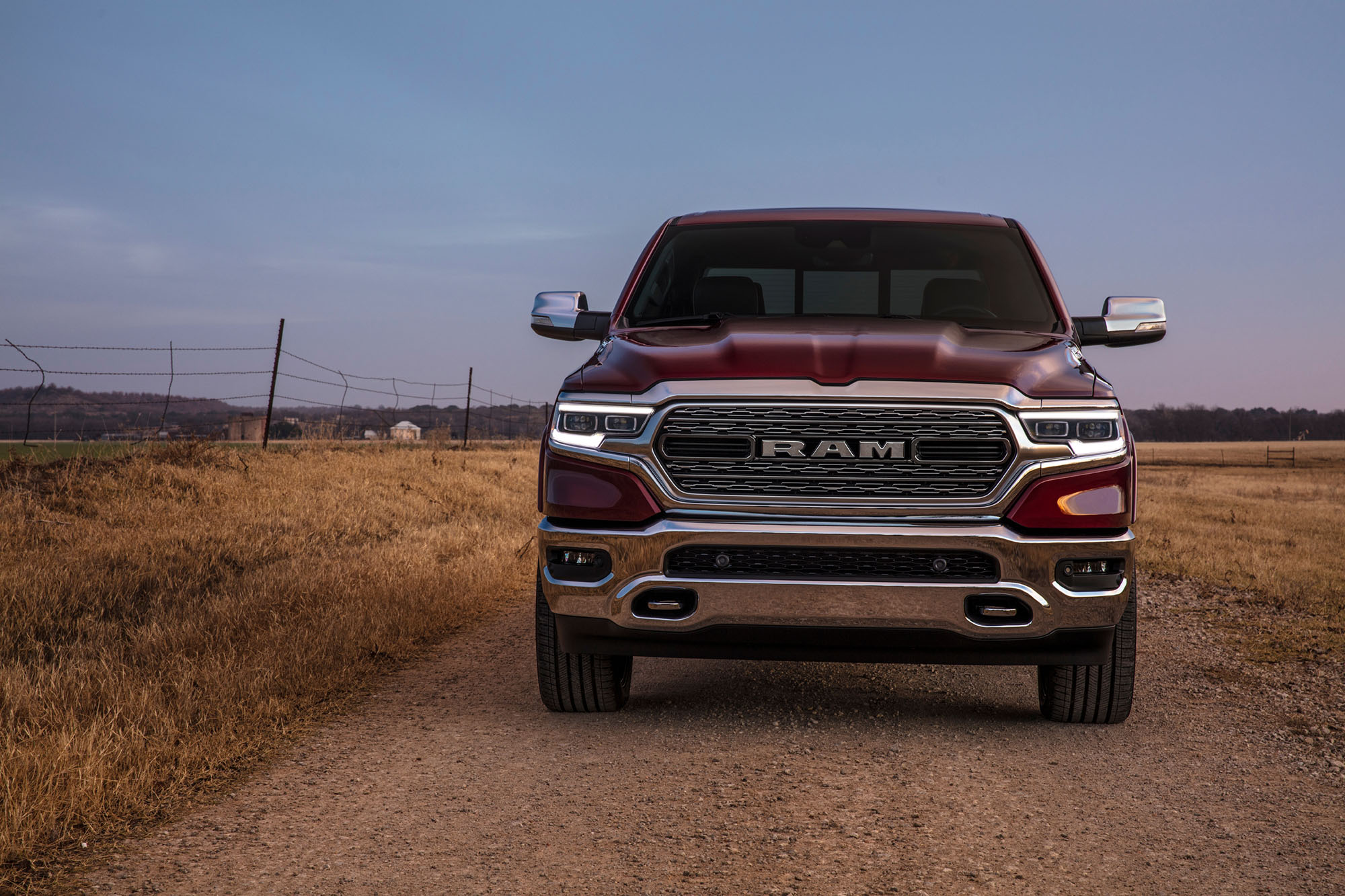 Red Ram 1500 truck driving on a dirt road.