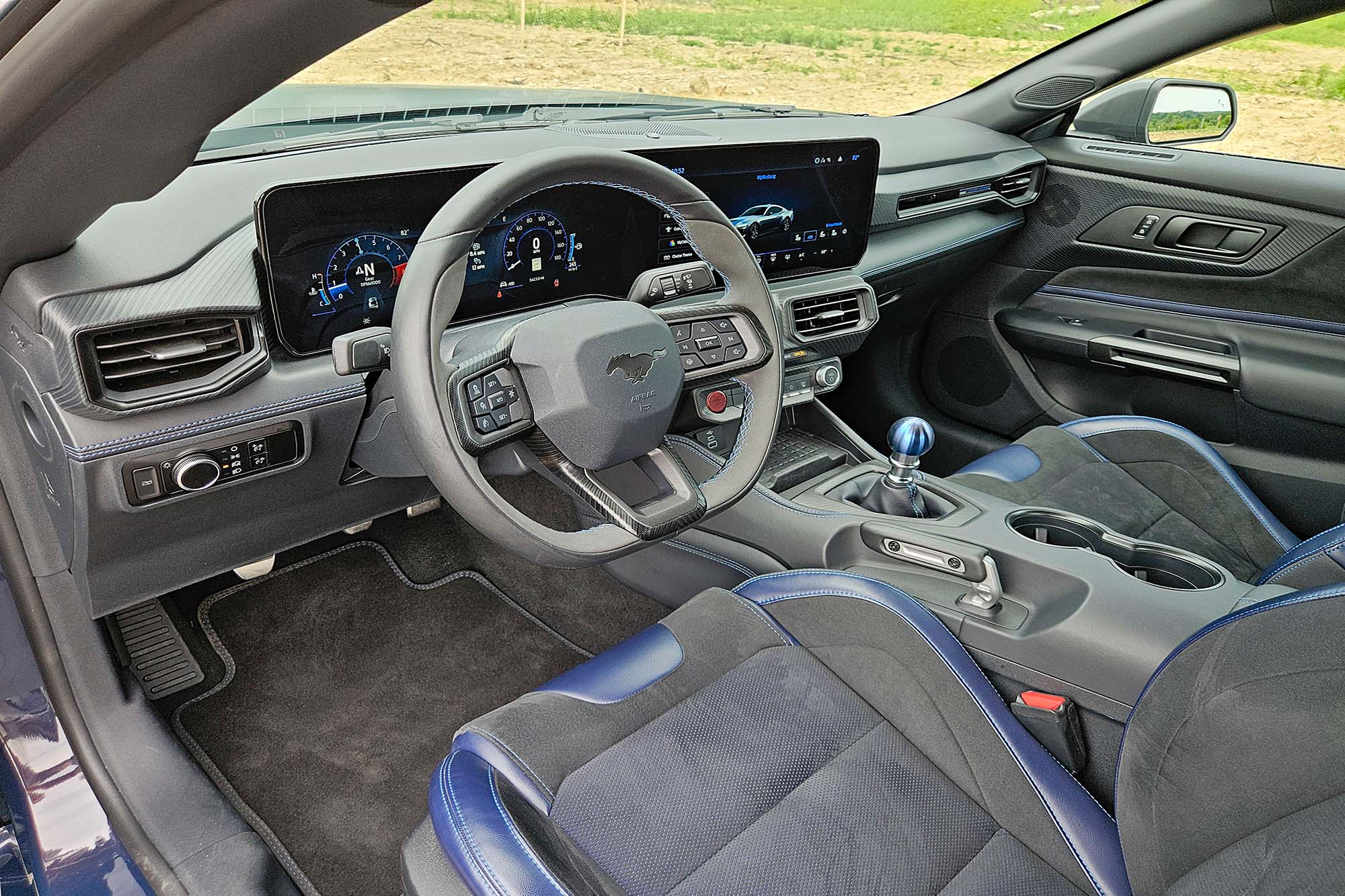 View of a 2024 Ford Mustang Dark Horse interior showing the dashboard, center console, and front seats.