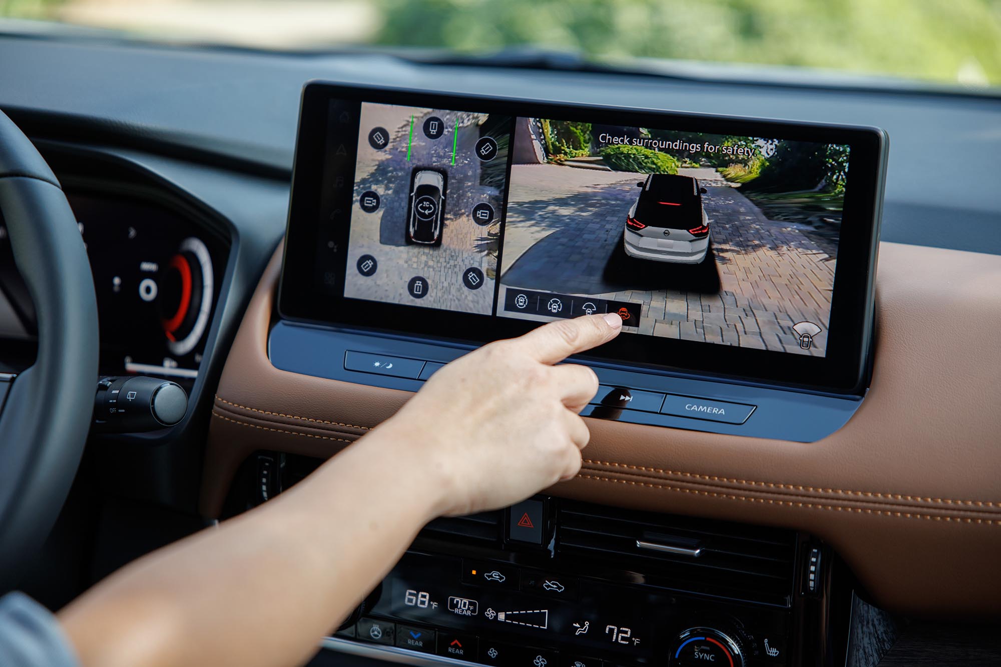 Infotainment screen with bird's-eye view of Nissan Rogue displayed.