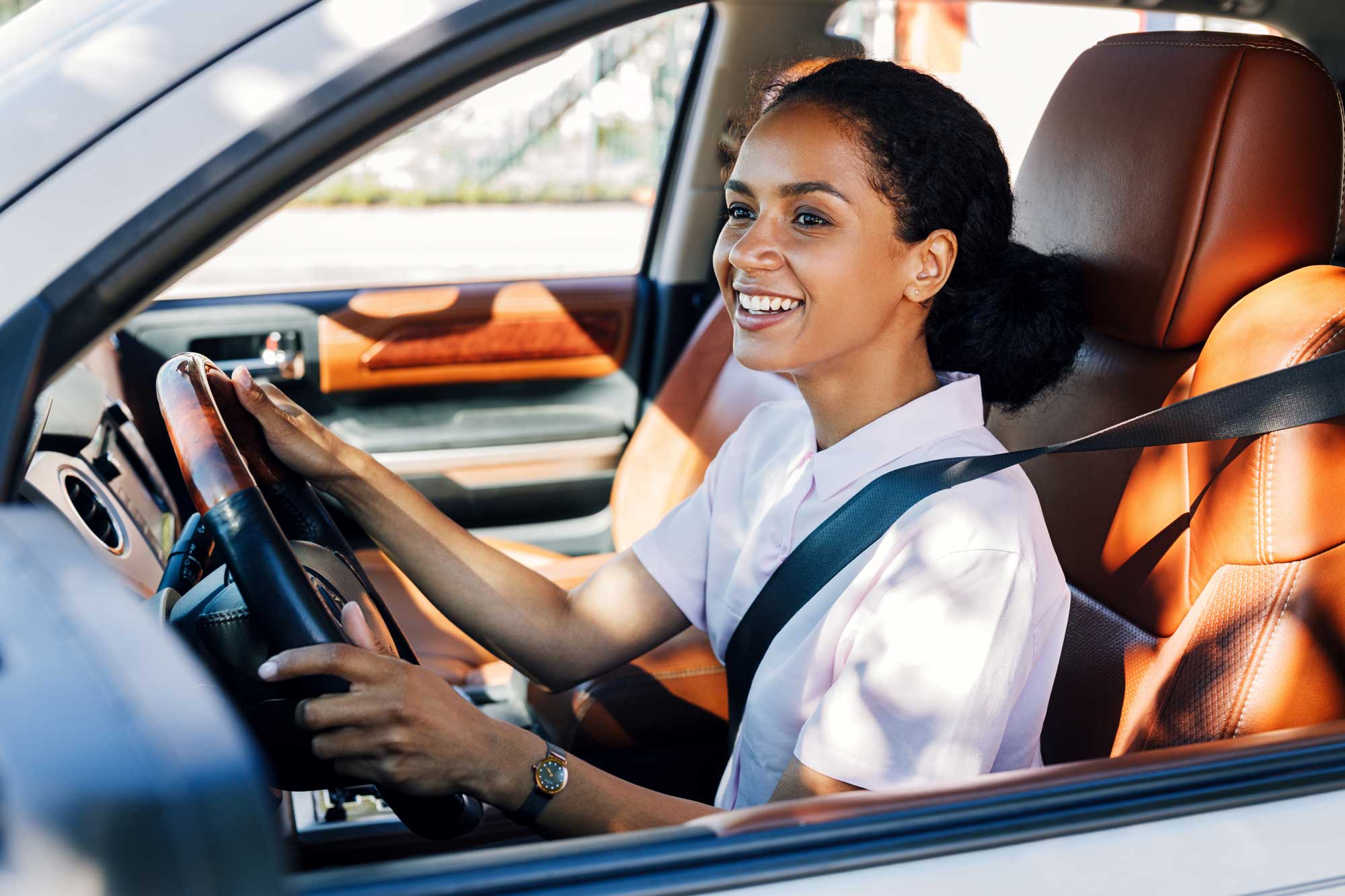 Person driving car with orange seats