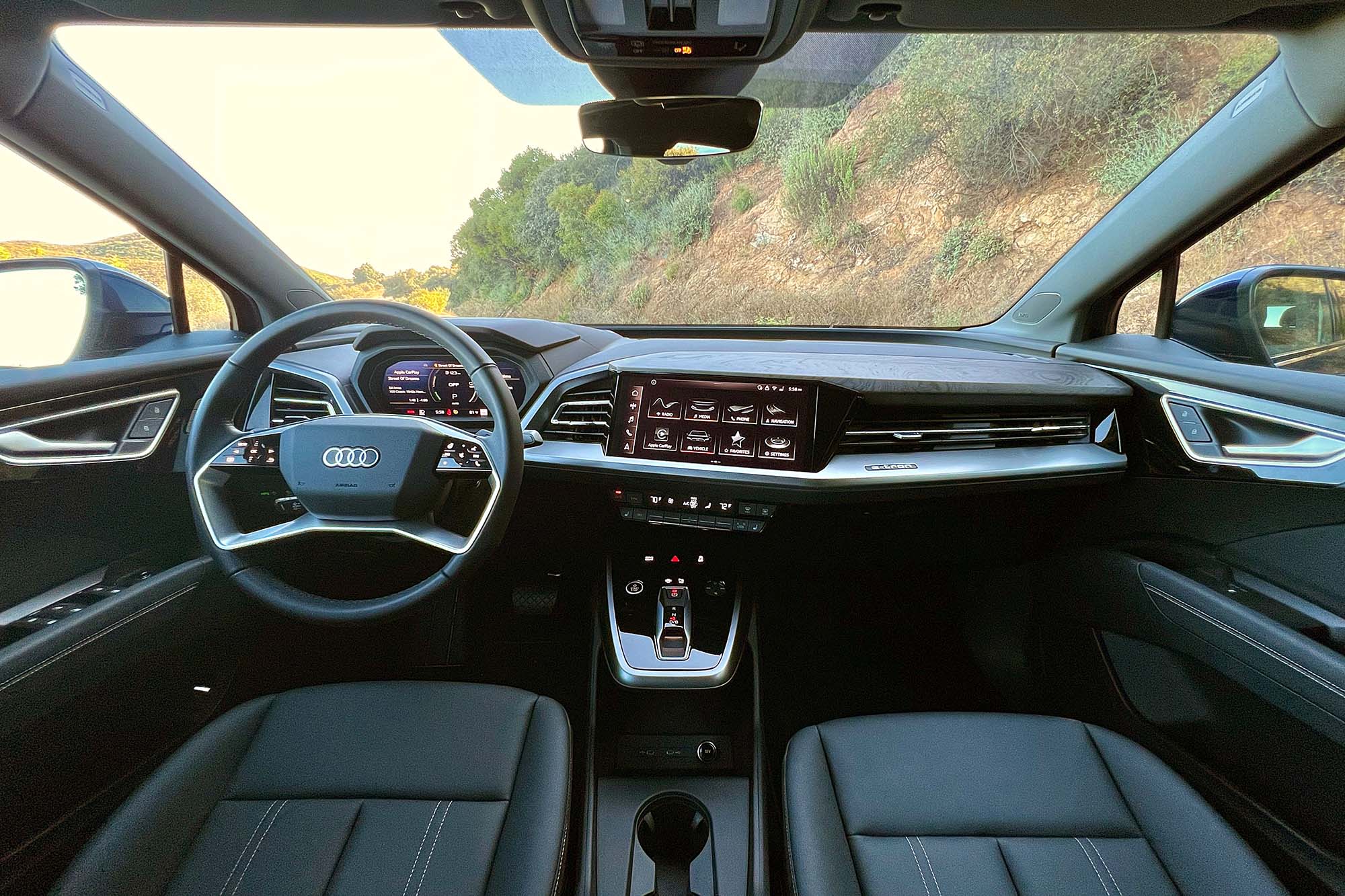 View of a 2024 Audi Q4 55 e-tron interior showing the dashboard and front seats.