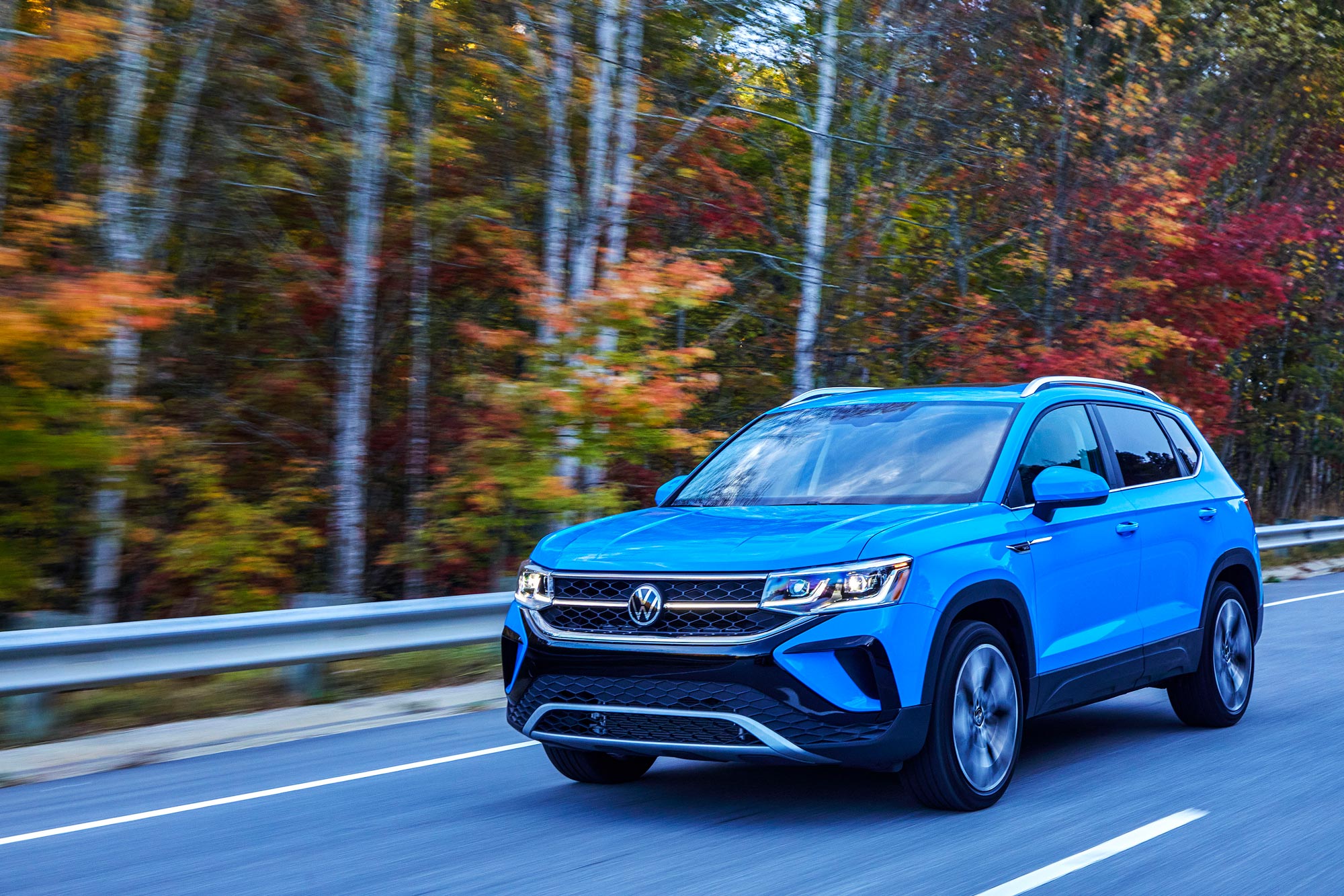 Blue 2024 Volkswagen Taos driving on a highway