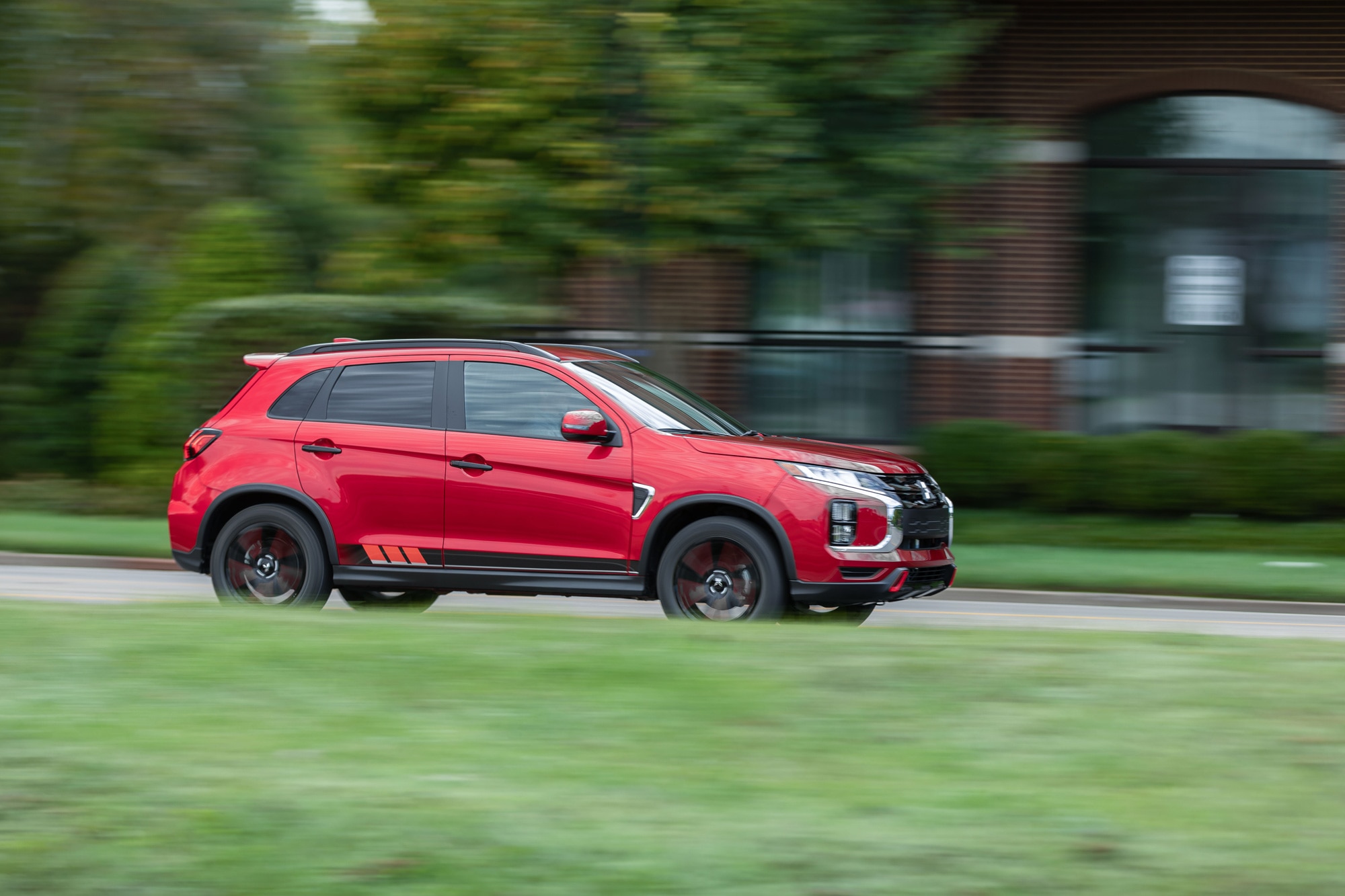 Red 2024 Mitsubishi Outlander Sport driving