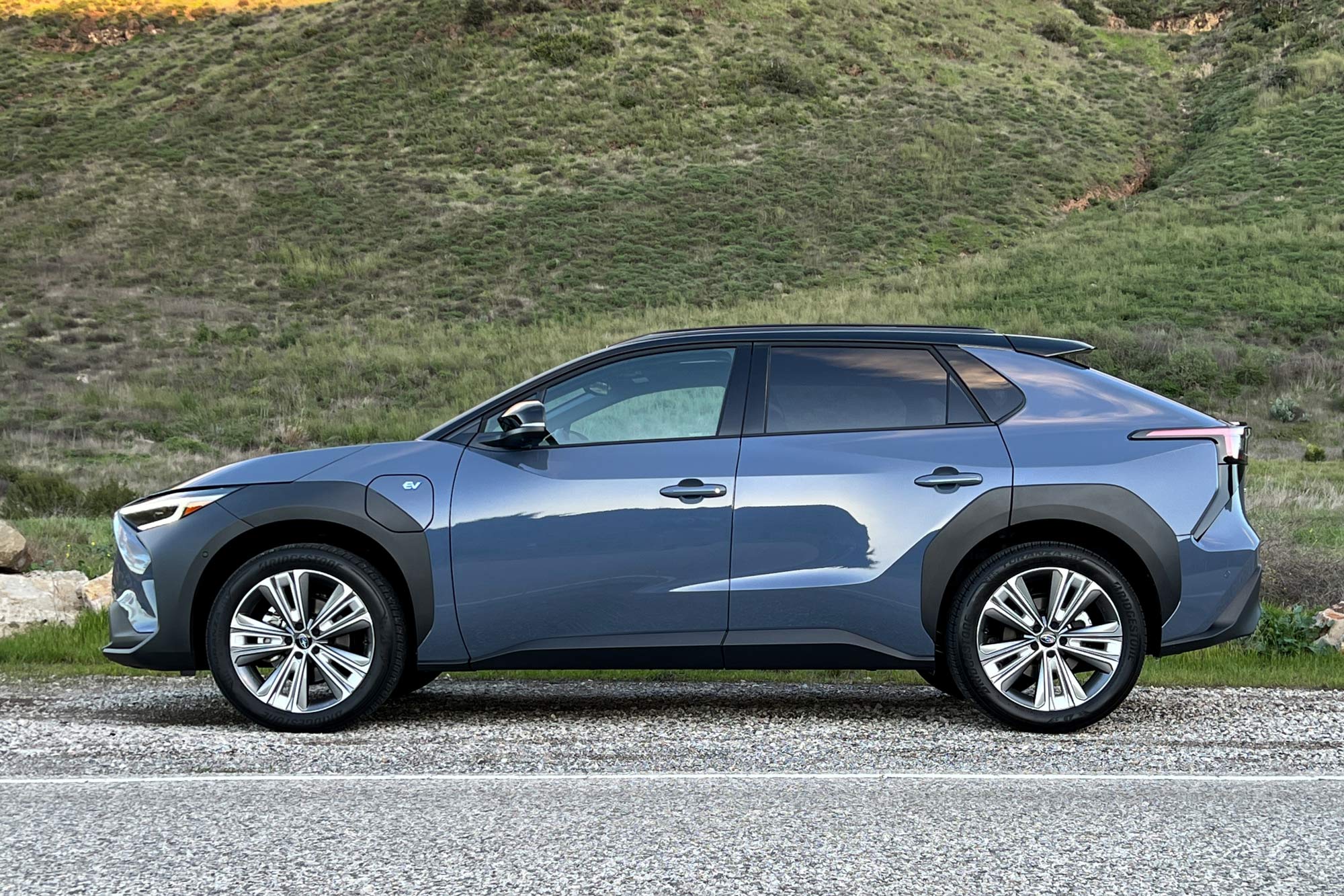 Side of a blue 2024 Subaru Solterra Touring