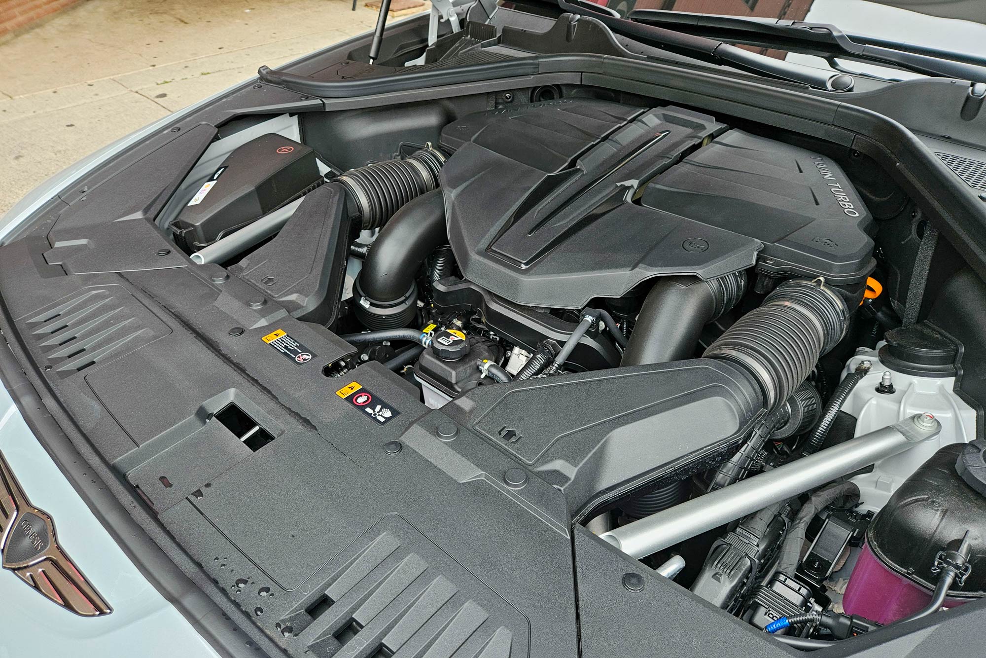 View of a 2025 Genesis GV80 Coupe E-Supercharged engine.