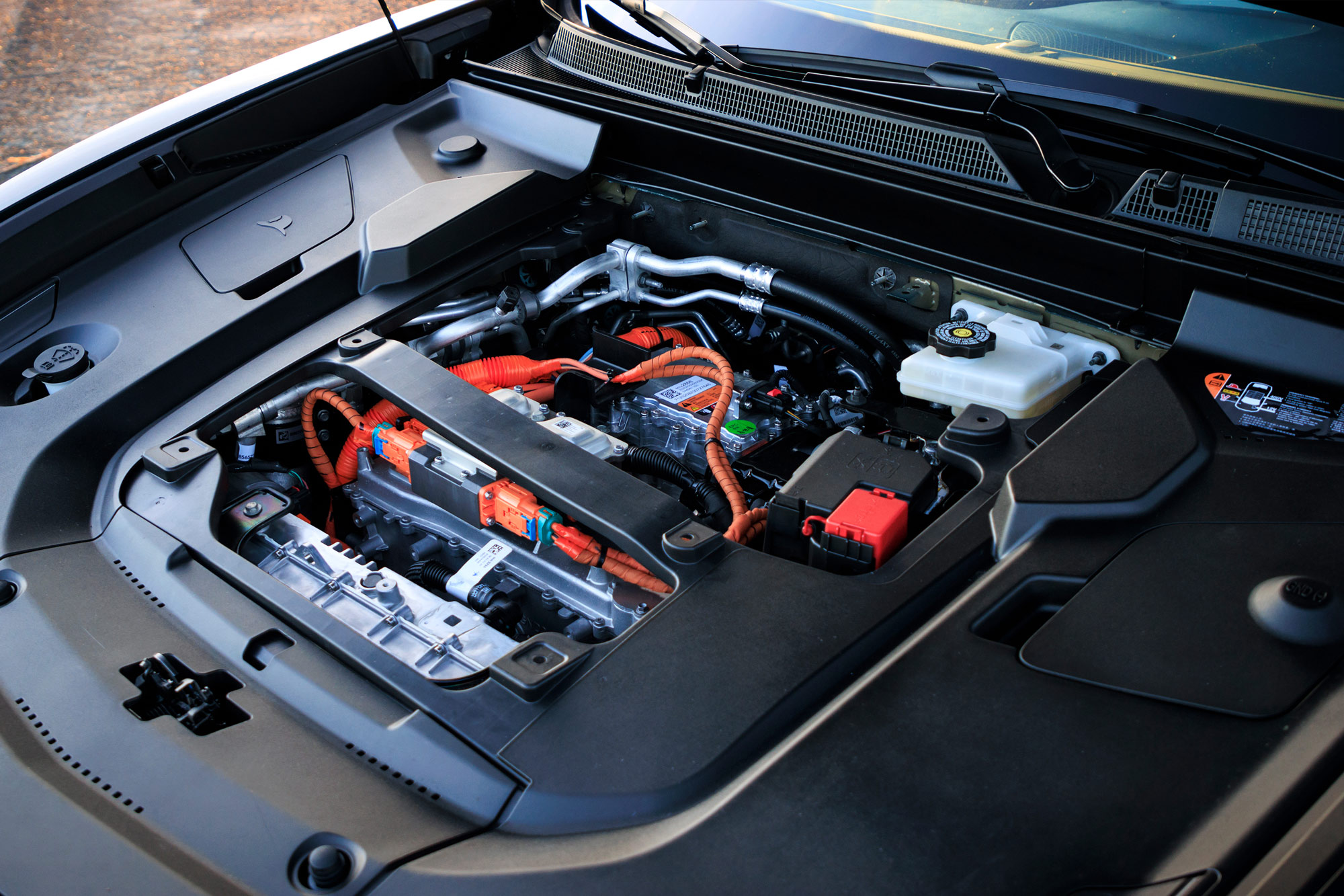 Electronics under the hood of a 2024 Cadillac Lyriq, with the decorative plastic cover removed