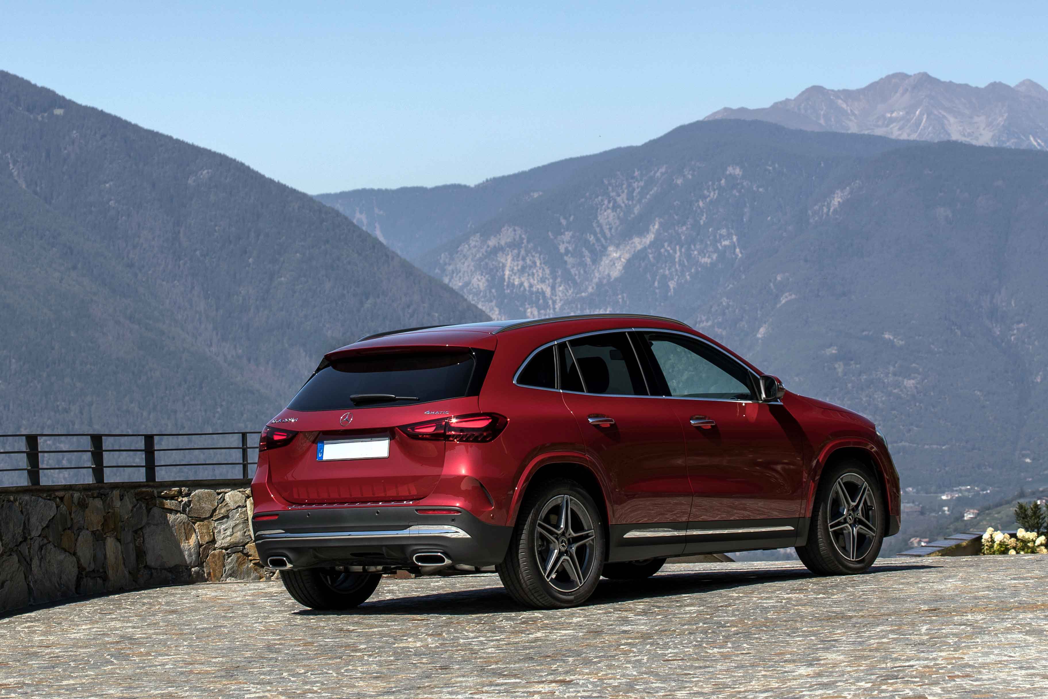 Red Mercedes-Benz GLA parked on a mountain overlook.