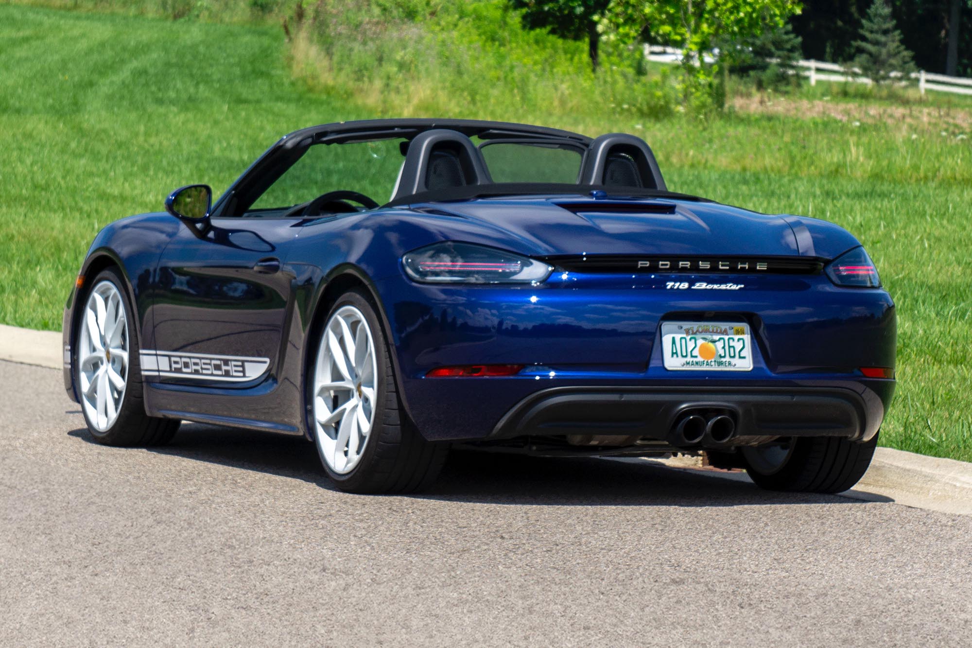 Rear-quarter view of a blue 2024 Porsche 718 Boxster Style Edition