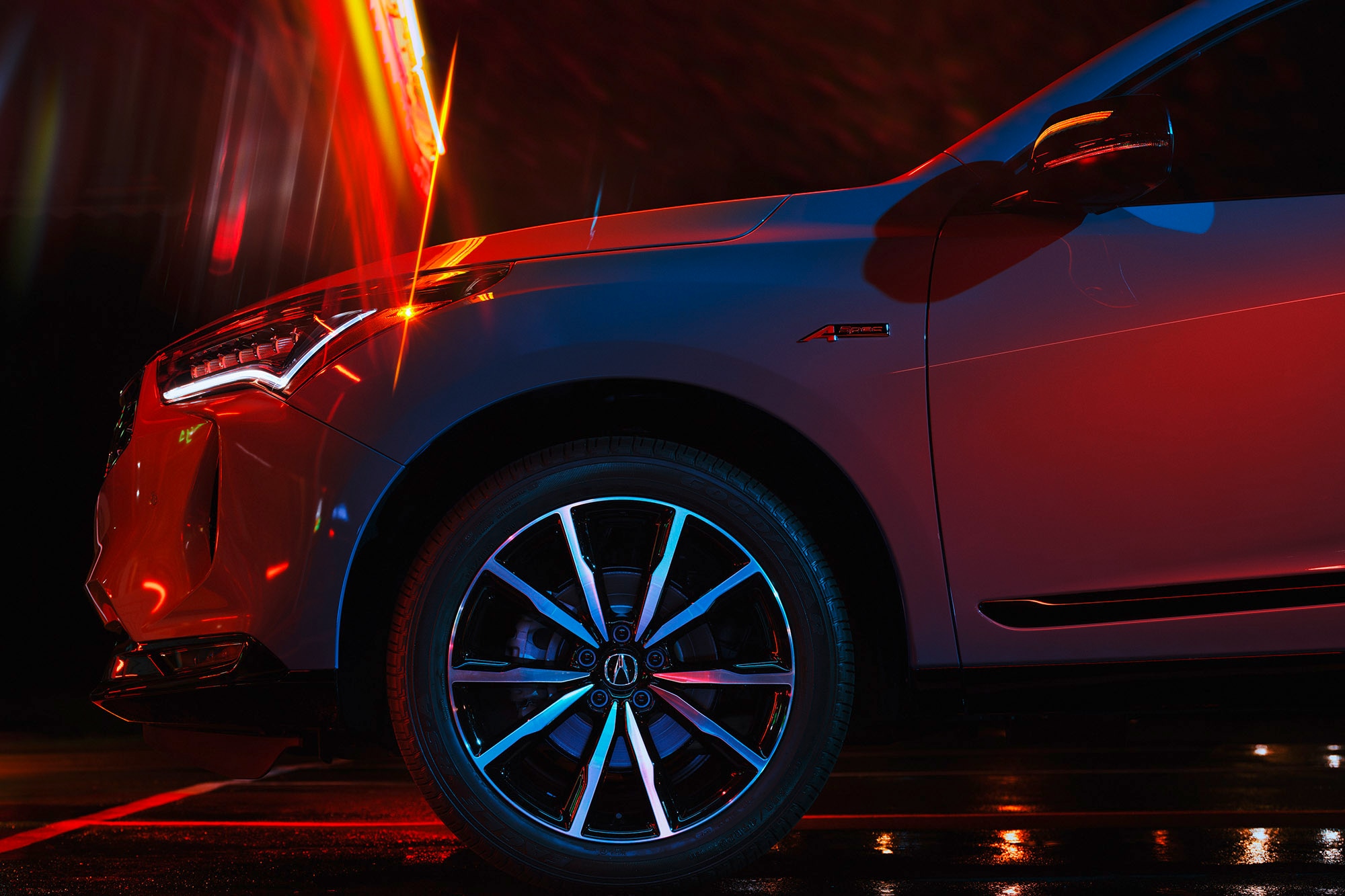 A stylized view of the front fender and wheel of a gray 2025 Acura RDX