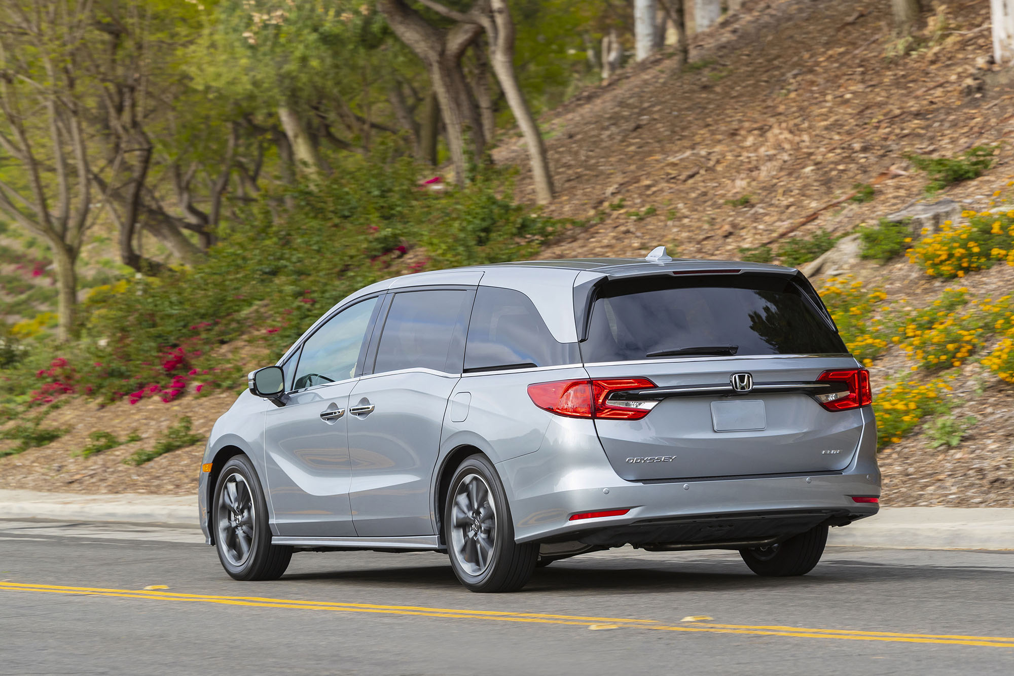 A rear three-quarter view of a silver Honda Odyssey.