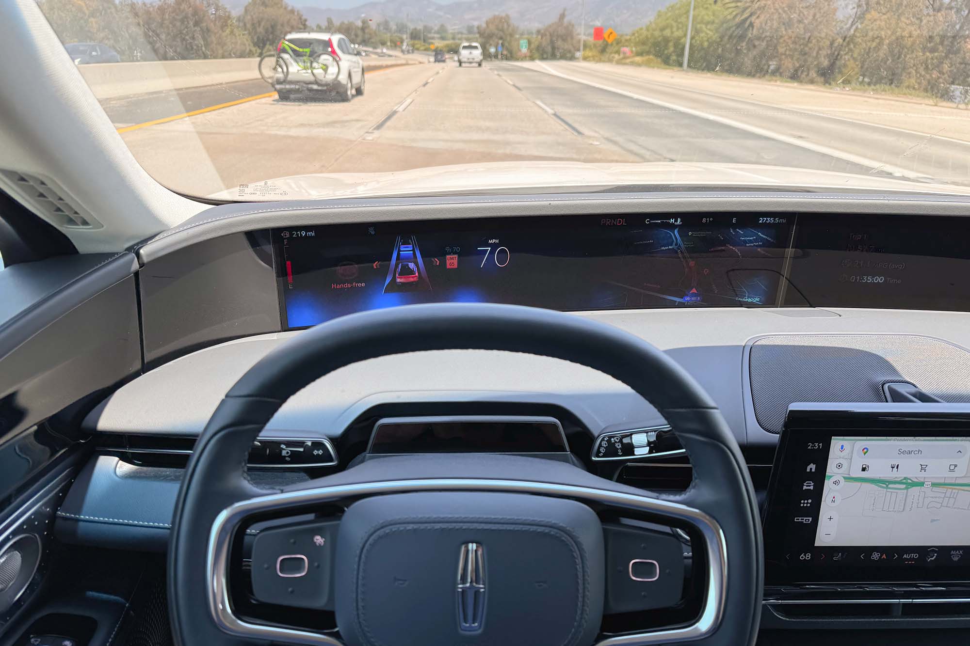 View of a 2024 Lincoln Nautilus interior showing the BlueCruise hands-free driving assistance system active on a Los Angeles freeway.