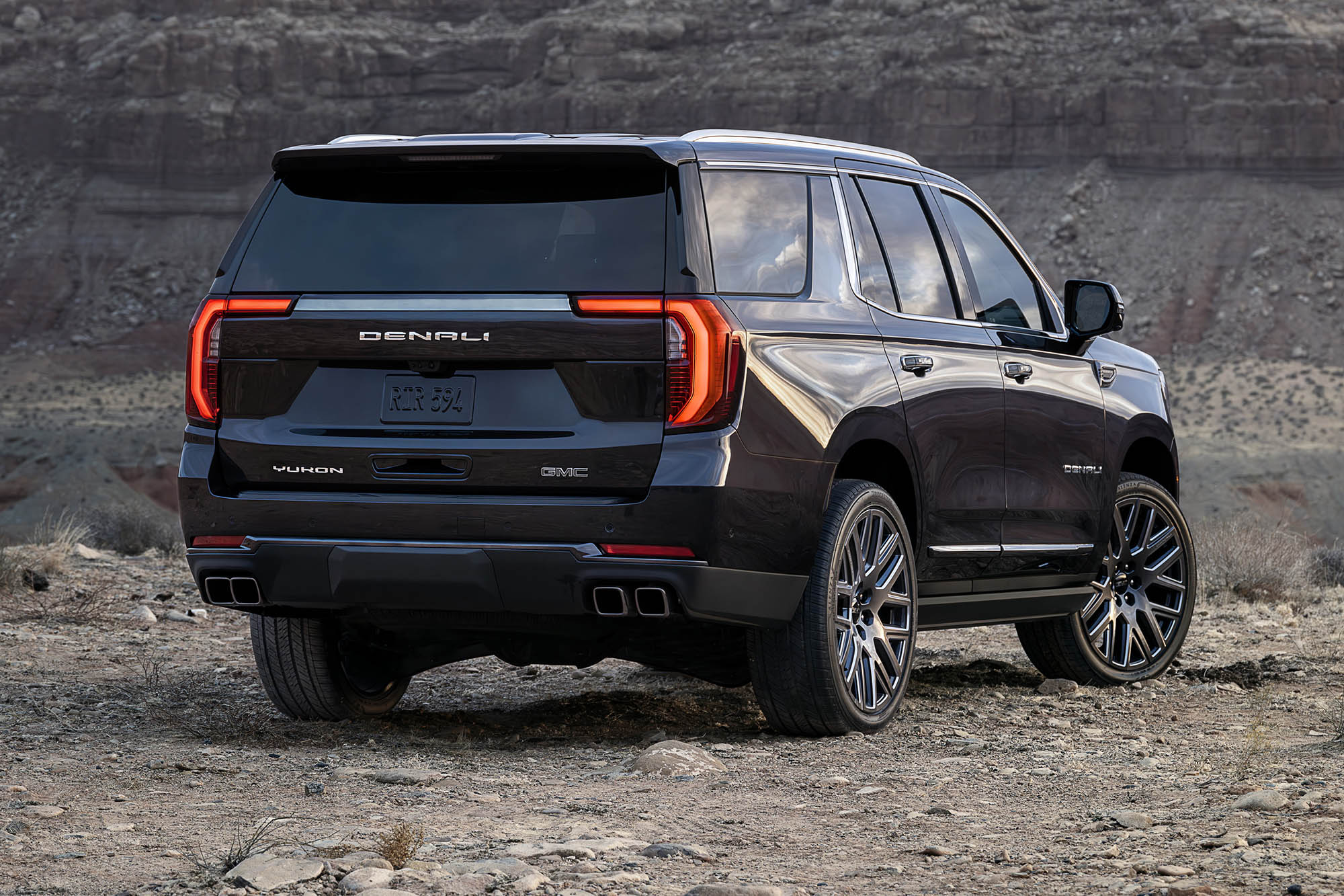 A right rear view of a black 2025 GMC Yukon