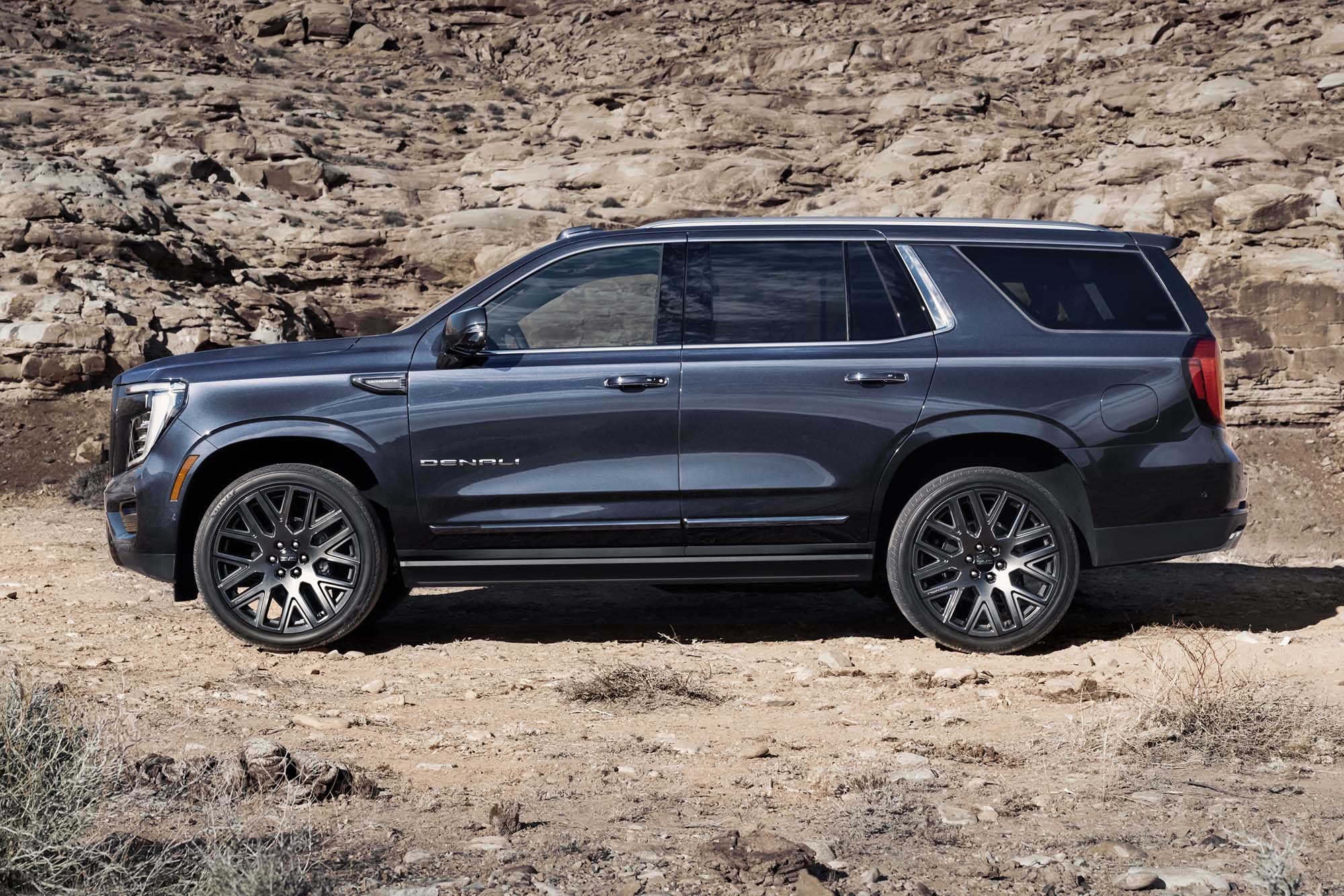 A side view of a black 2025 GMC Yukon