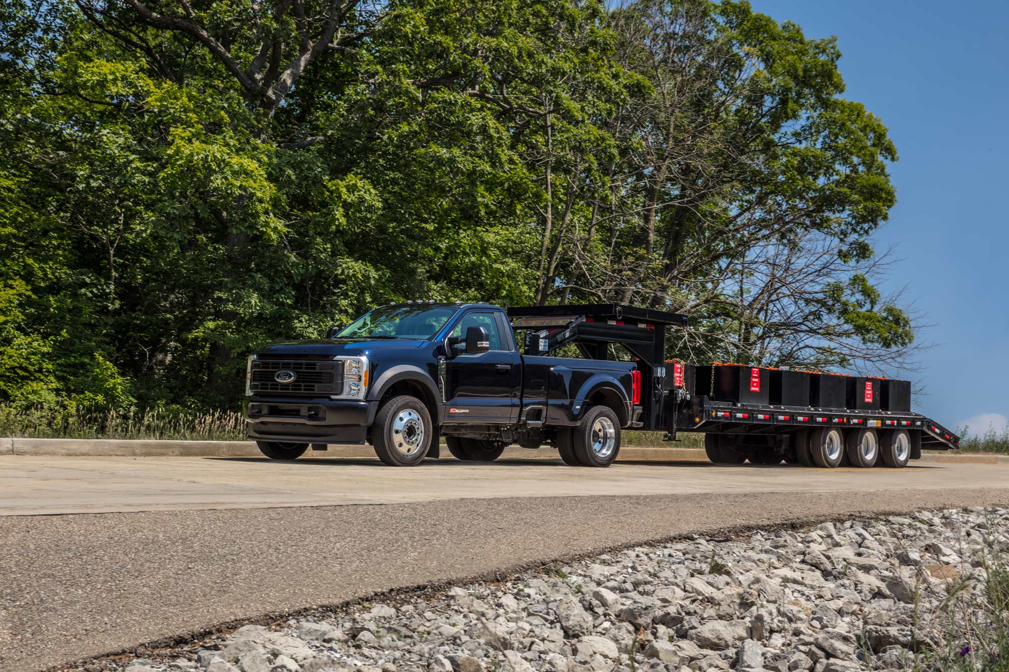 2024 Ford F-450 single cab with heavy-duty fifth-wheel trailer.