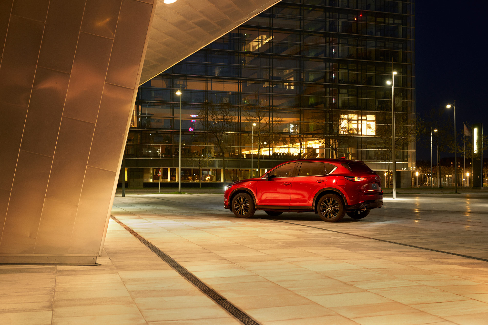 2024 Mazda CX-5 parked by building at night.