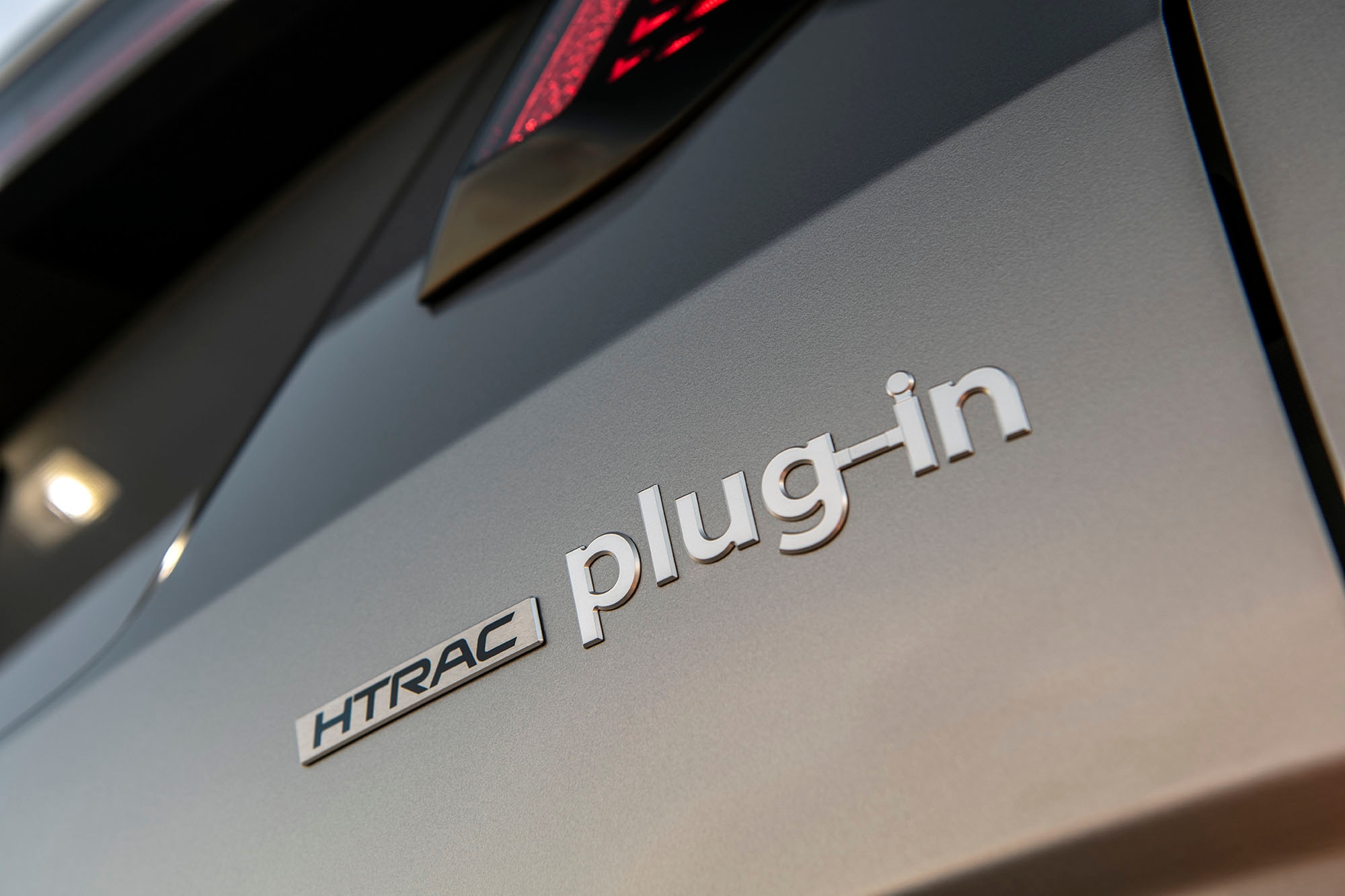 HTRAC plug-in badge of a Hyundai Tucson Plug-In Hybrid vehicle.