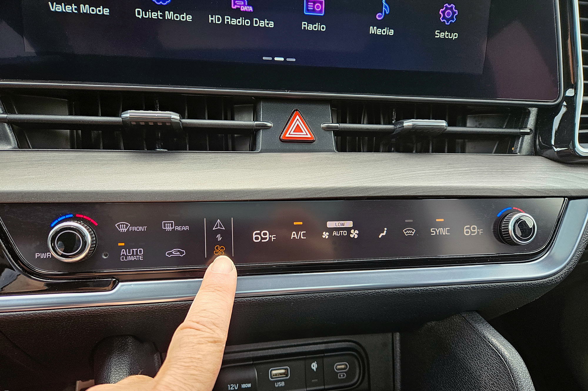 2024 Kia Sportage X-Pro Prestige interior showing the dual-function climate and infotainment system controls on the dashboard