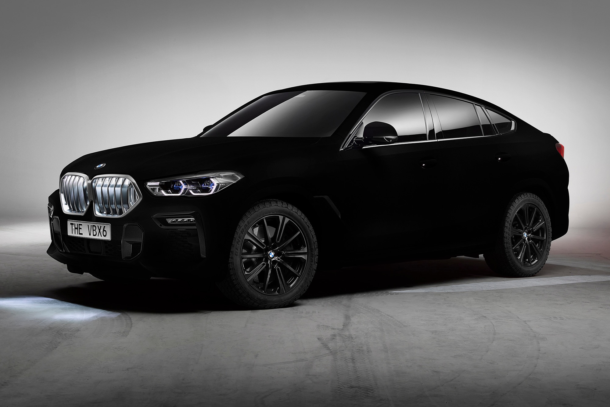 A front-left view of a 2020 BMW X6 coated in Vantablack