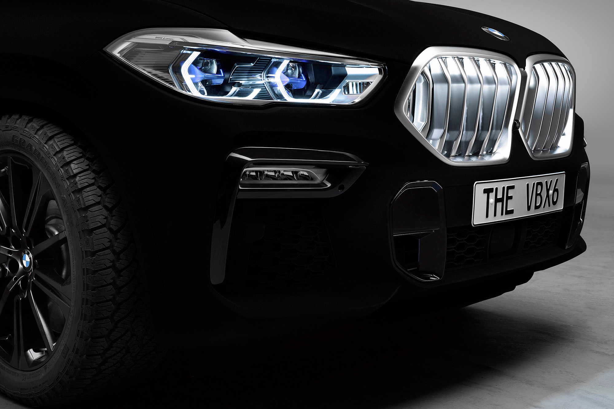 A detail view of the grille of a 2020 BMW X6 coated in Vantablack