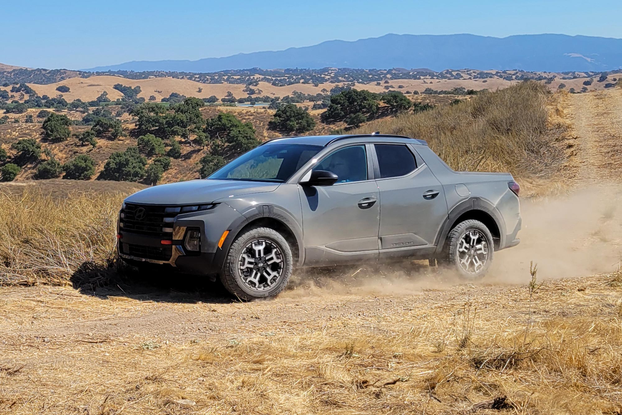 2025 Hyundai Santa Cruz XRT driving on a dirt road.