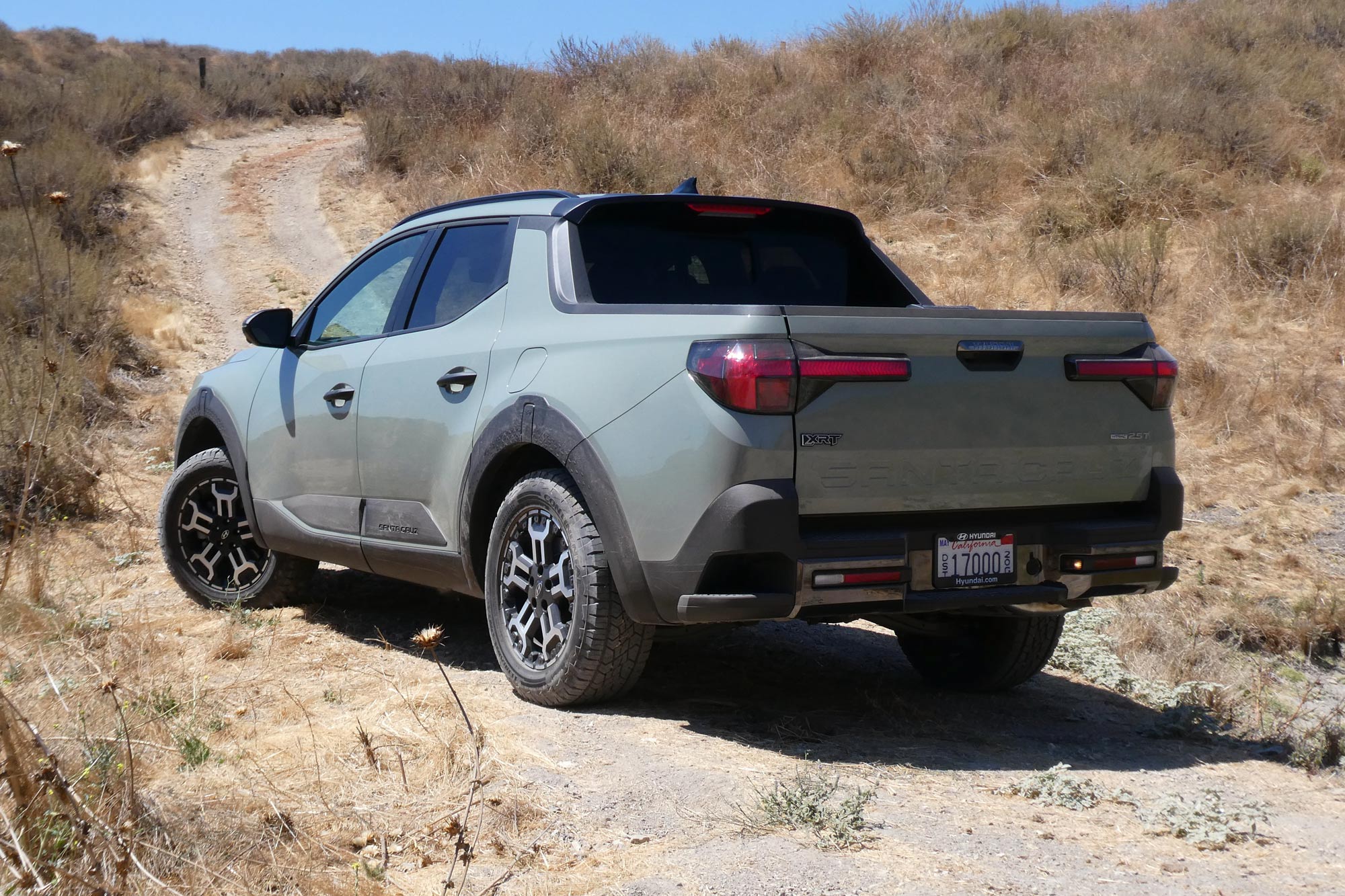 2025 Hyundai Santa Cruz XRT in Sage Green parked on a trail with blue sky in the background.