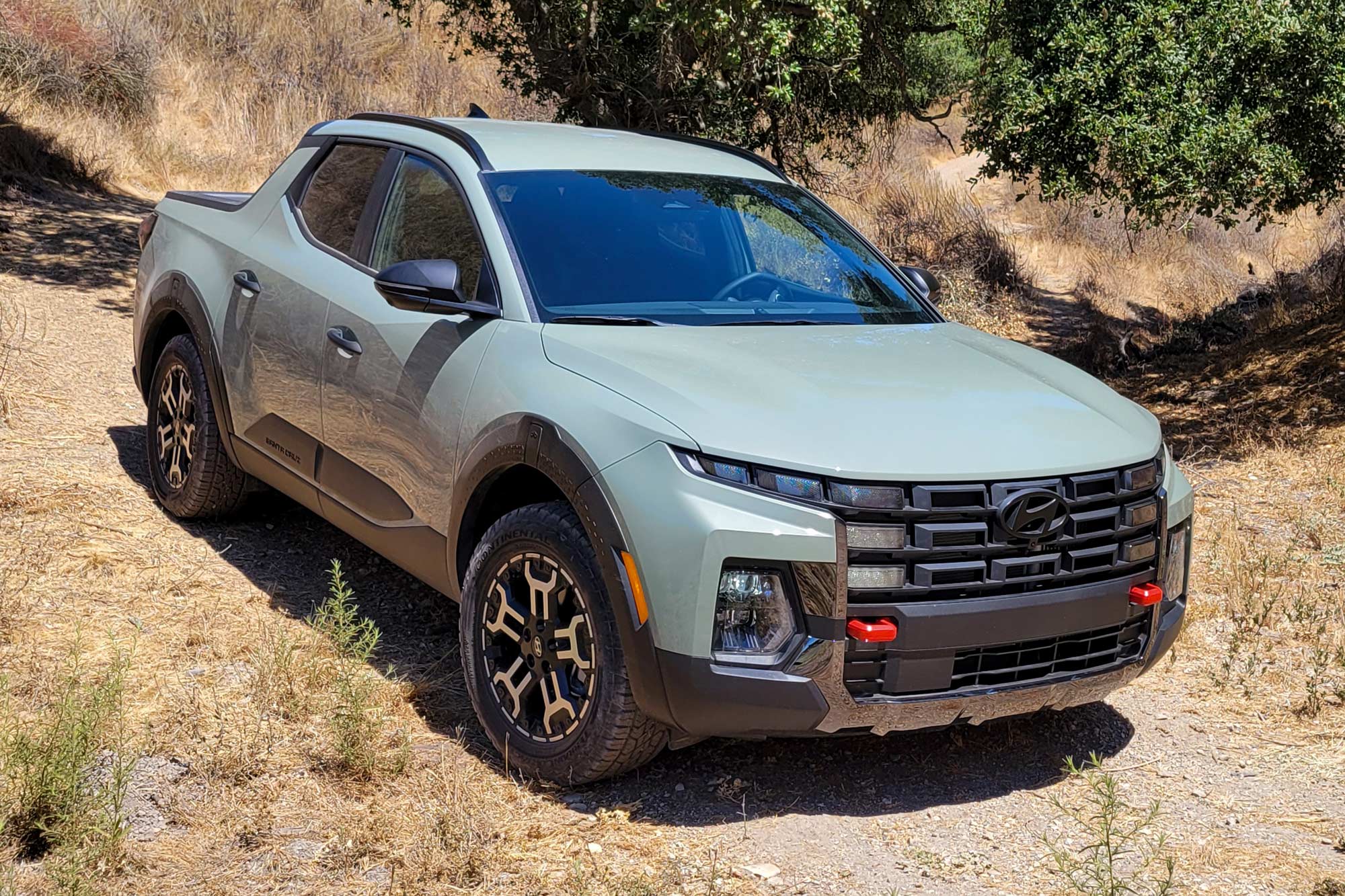 2025 Hyundai Santa Cruz XRT in Hampton Gray driving down a hill.