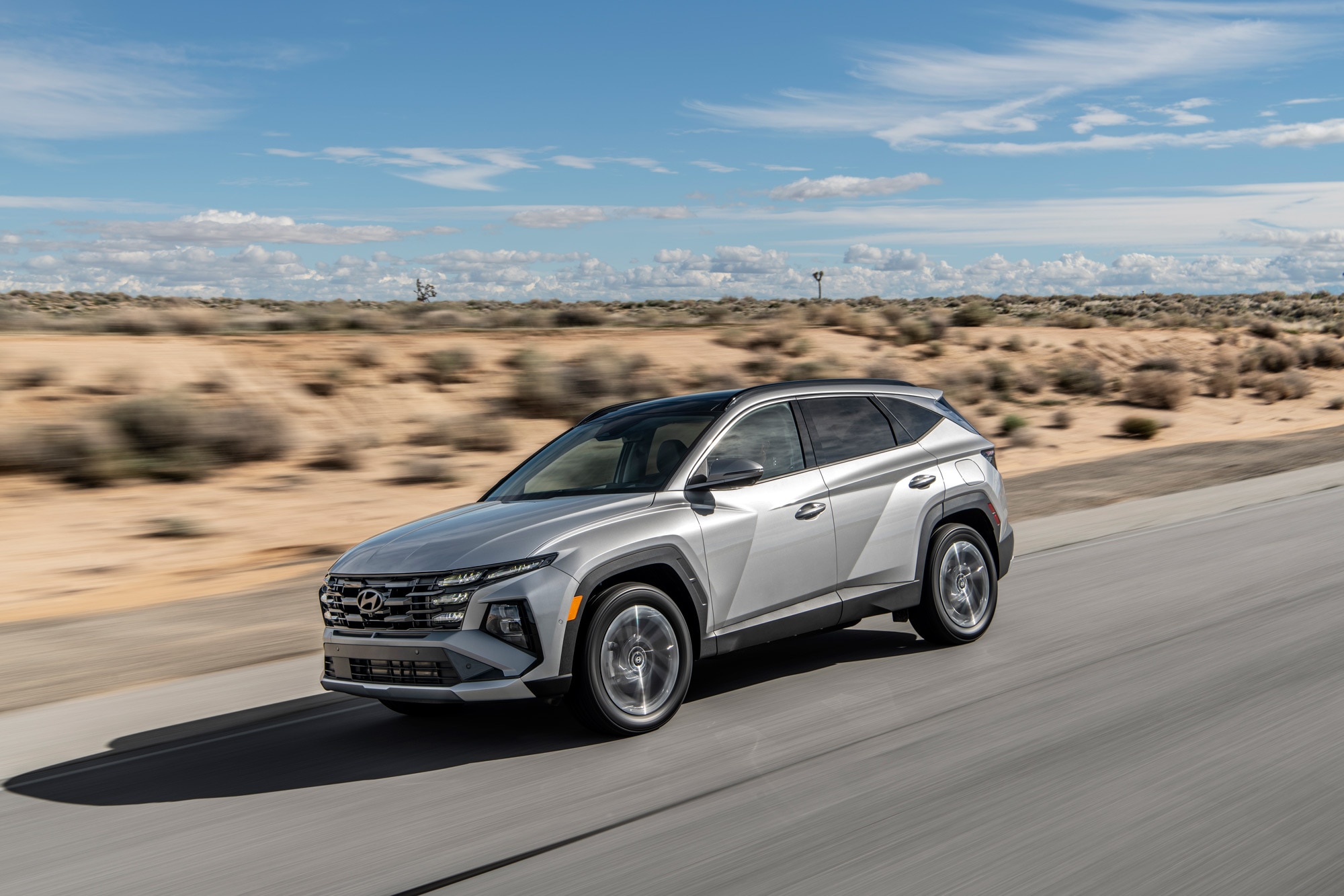 2025 Hyundai Tucson driving down a desert highway.