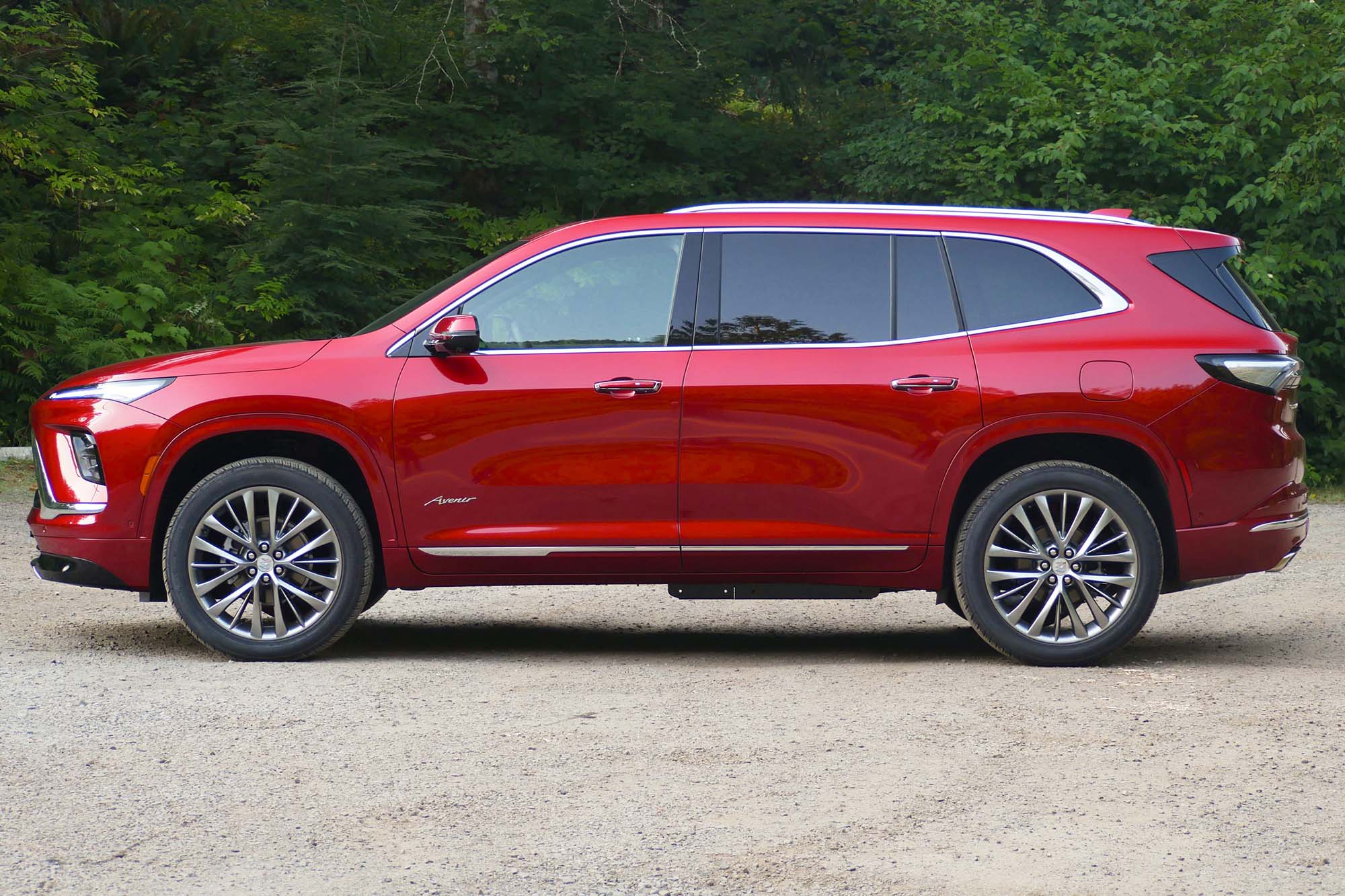 Profile view of the 2025 Buick Enclave Avenir in Cherry Red